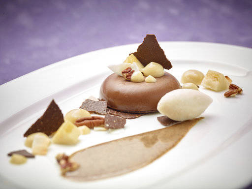 This March 17, 2017 photo provided by The Culinary Institute of America shows the “Three Pleasures” chocolate-banana panna cotta dessert in Hyde Park, N.Y. This dish is from a recipe by the CIA. (Phil Mansfield/The Culinary Institute of America via AP)