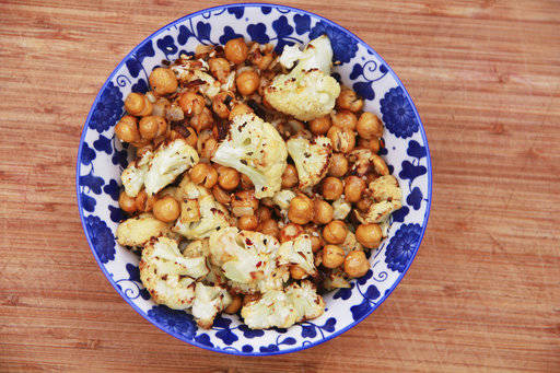 This March 6, 2017 photo shows a cauliflower, chickpea and onion side dish in Coronado, Calif. This dish is from a recipe by Melissa d’Arabian. (Melissa d’Arabian via AP)