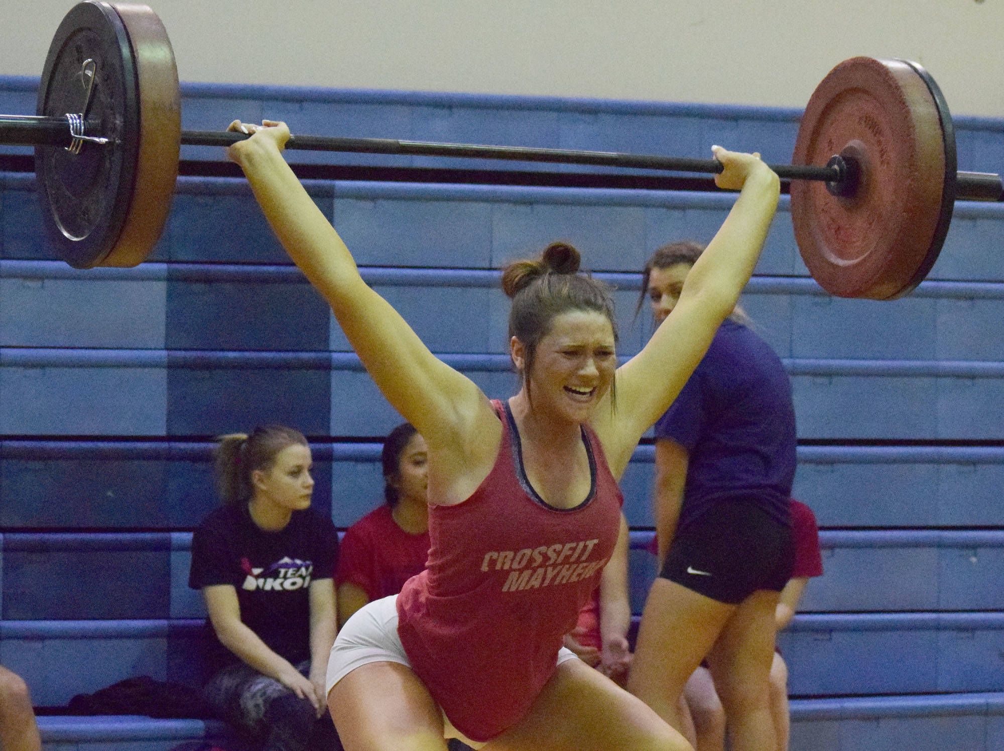 Kenai Central senior Lara Creighton cleans and jerks Wednesday evening at the 11th biannual CrossFit Competition at Soldotna High School. (Photo by Joey Klecka/Peninsula Clarion)