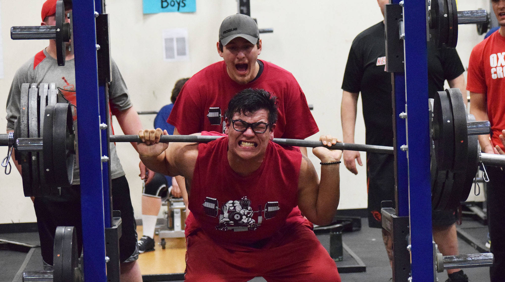 Kenai Central senior Jonathan Delgado attempts to break the 11th-12th grade boys squat record Wednesday evening at the 11th biannual CrossFit Competition at Soldotna High School. (Photo by Joey Klecka/Peninsula Clarion)