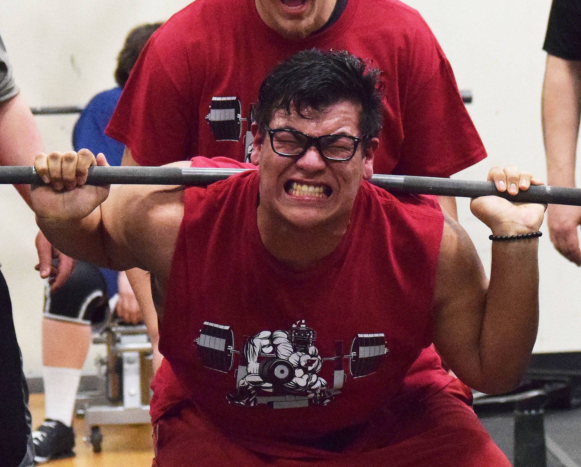 Kenai Central senior Jonathan Delgado attempts to break the 11th-12th grade boys squat record Wednesday evening at the 11th biannual CrossFit Competition at Soldotna High School. (Photo by Joey Klecka/Peninsula Clarion)