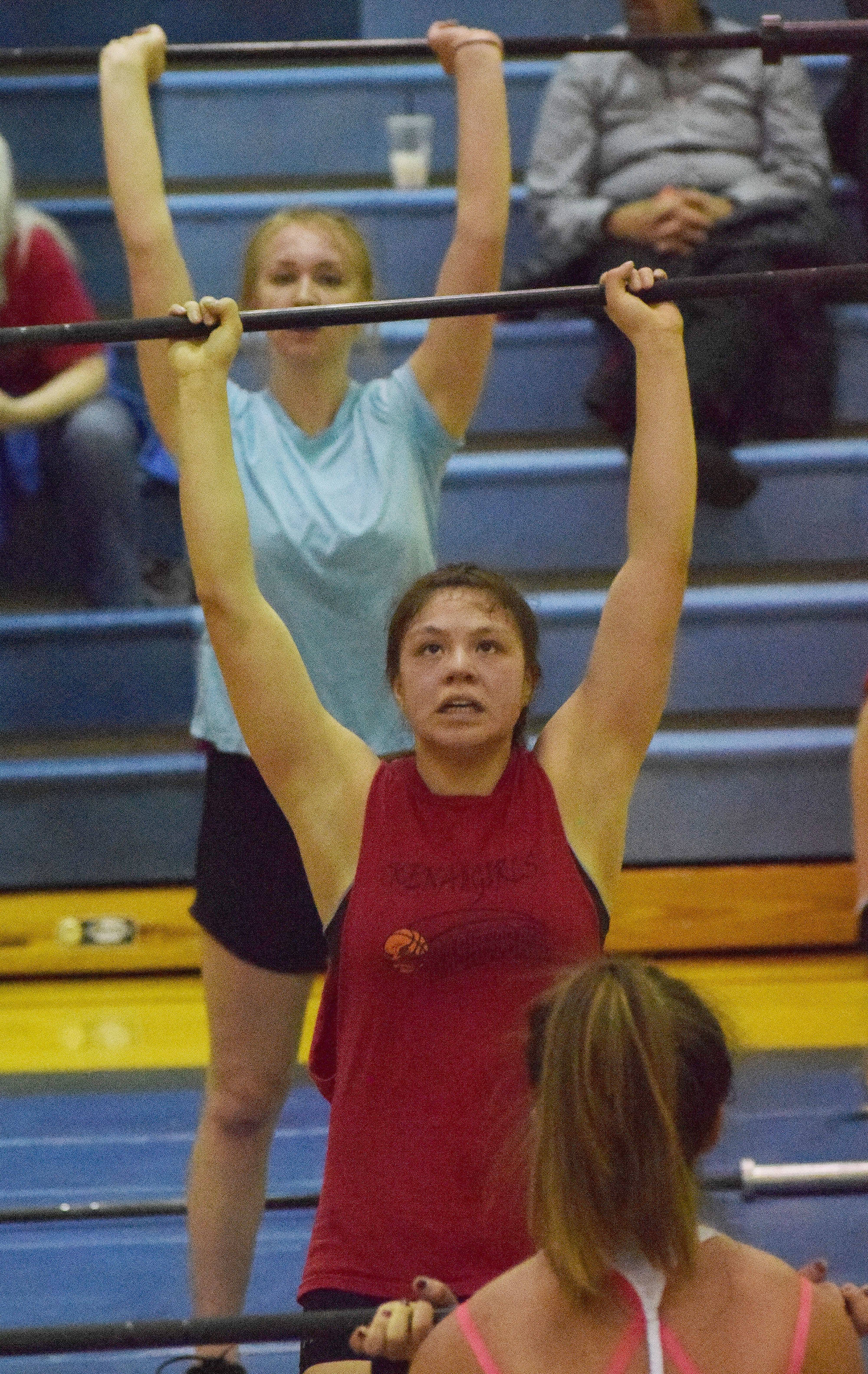 Kenai Central senior Julieanne Wilson (middle) lifts during the Fight Gone Bad event Wednesday evening at the 11th biannual CrossFit Competition at Soldotna High School. (Photo by Joey Klecka/Peninsula Clarion)