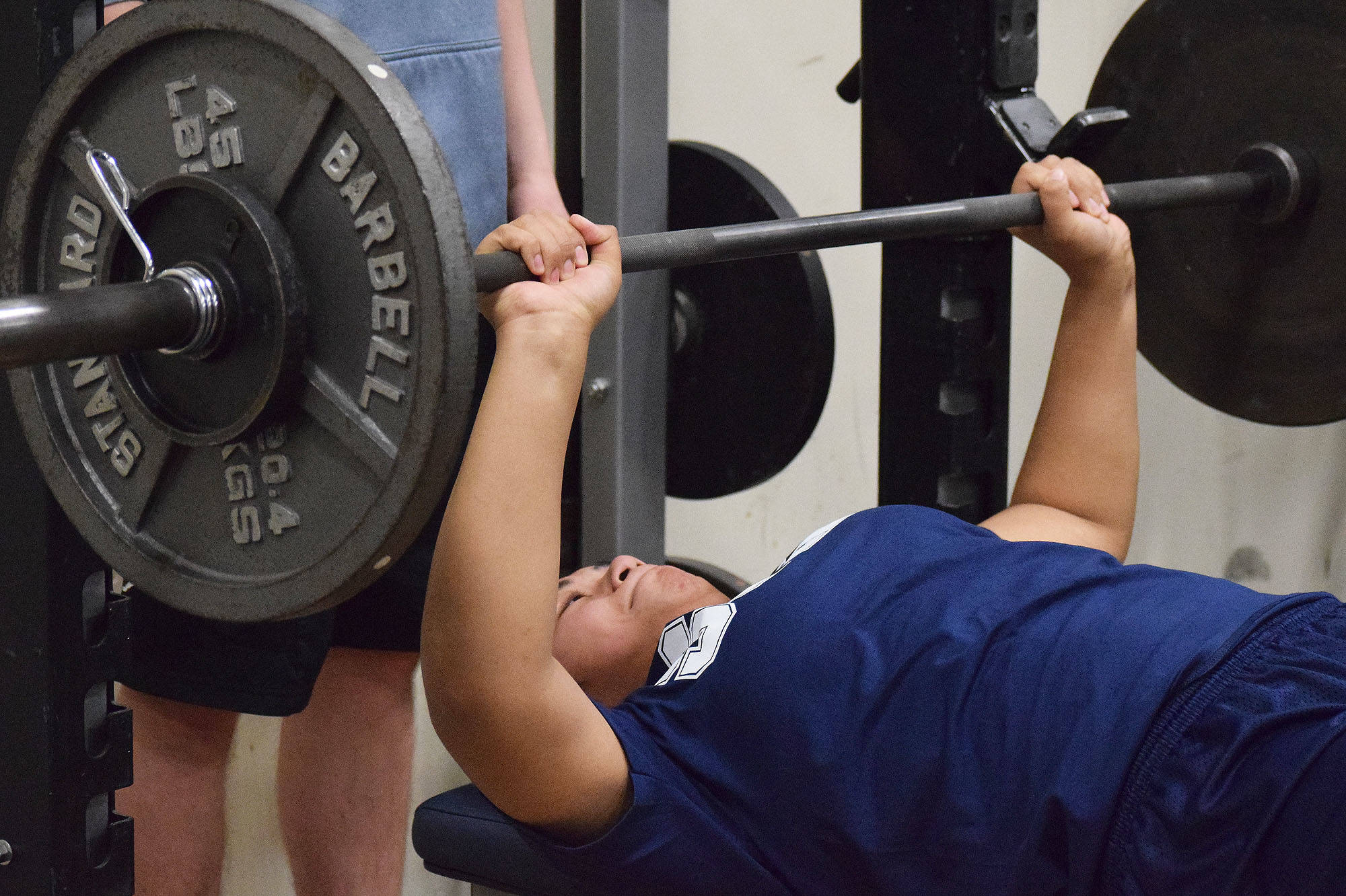 Soldotna freshman Ituau Tuisaula benches in the 9th-10th grade girls contest Wednesday evening at the 11th biannual CrossFit Competition at Soldotna High School. (Photo by Joey Klecka/Peninsula Clarion)