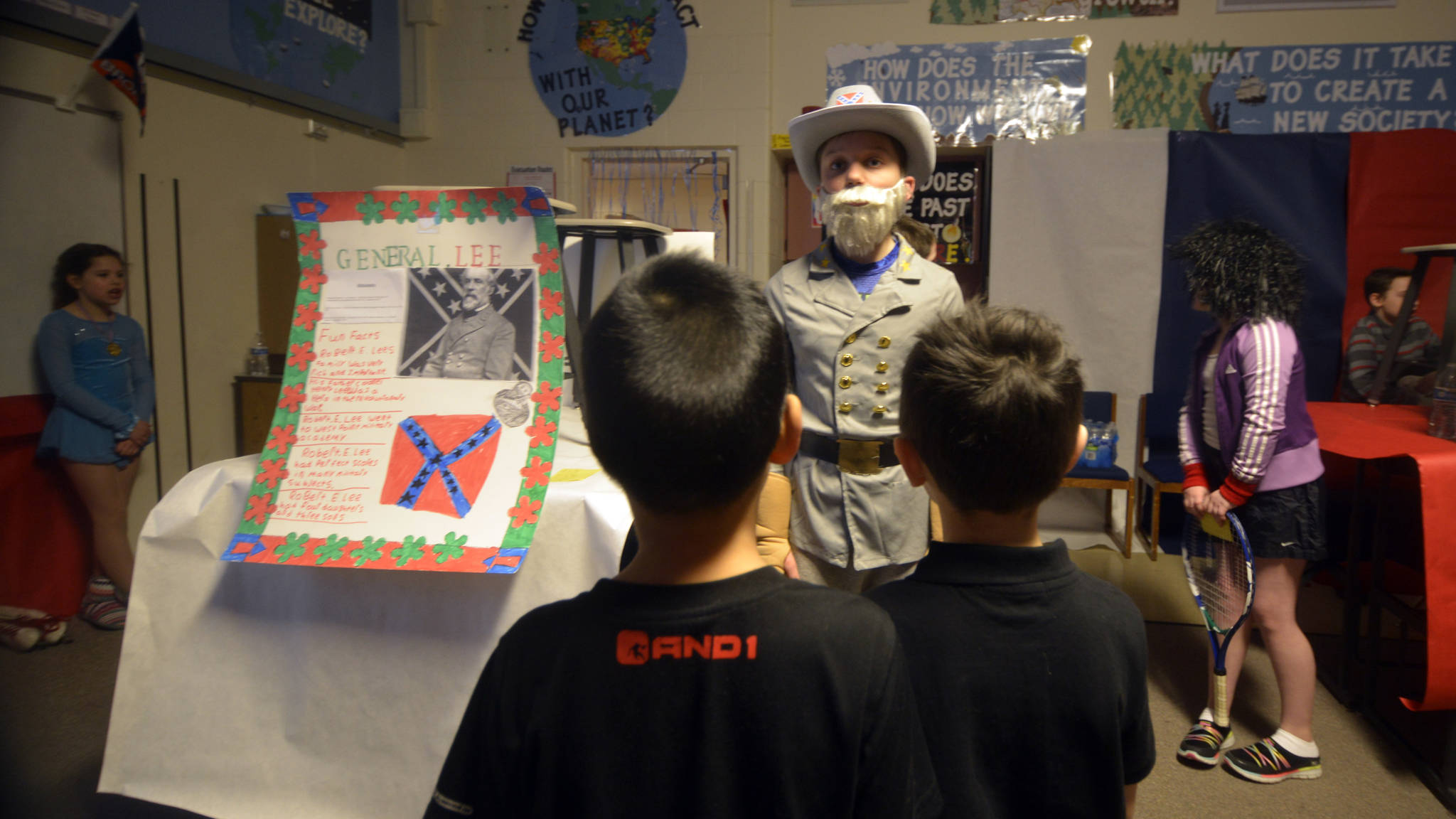 Jed Davis of Adrianne Bosic's class at Nikiski North Star Elementary recited his speech on Bob Ross, host of "The Joy of Painting," at the school's wax museum on Thursday, March 30. Davis sported Ross' signature hair and his pet, Peapod the Pocket Squirrel. (Kat Sorensen/Peninsula Clarion)