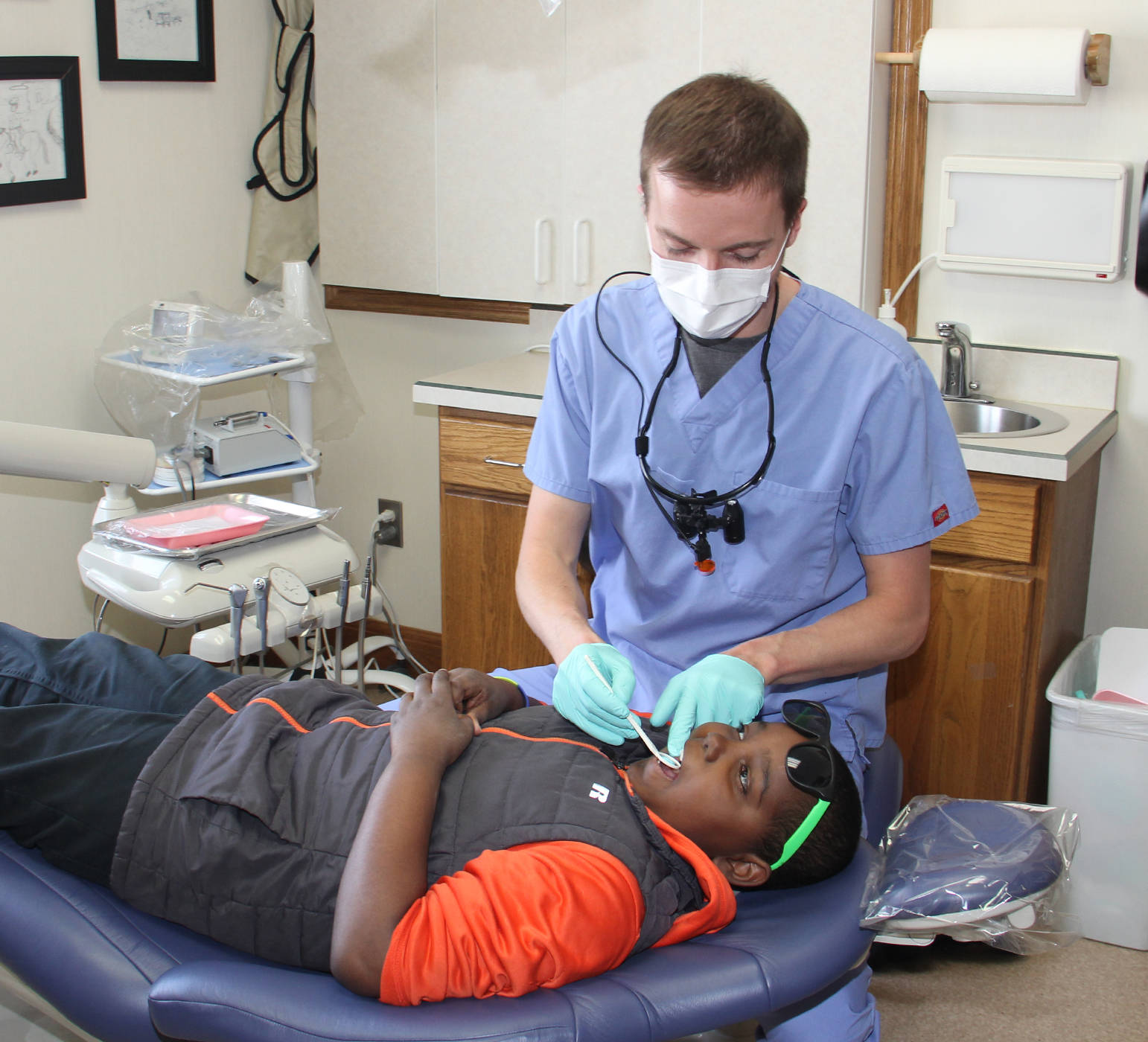 Dr. Owens DMD gives 9-year-old Jomar Paredes a checkup during Free Dental Day.