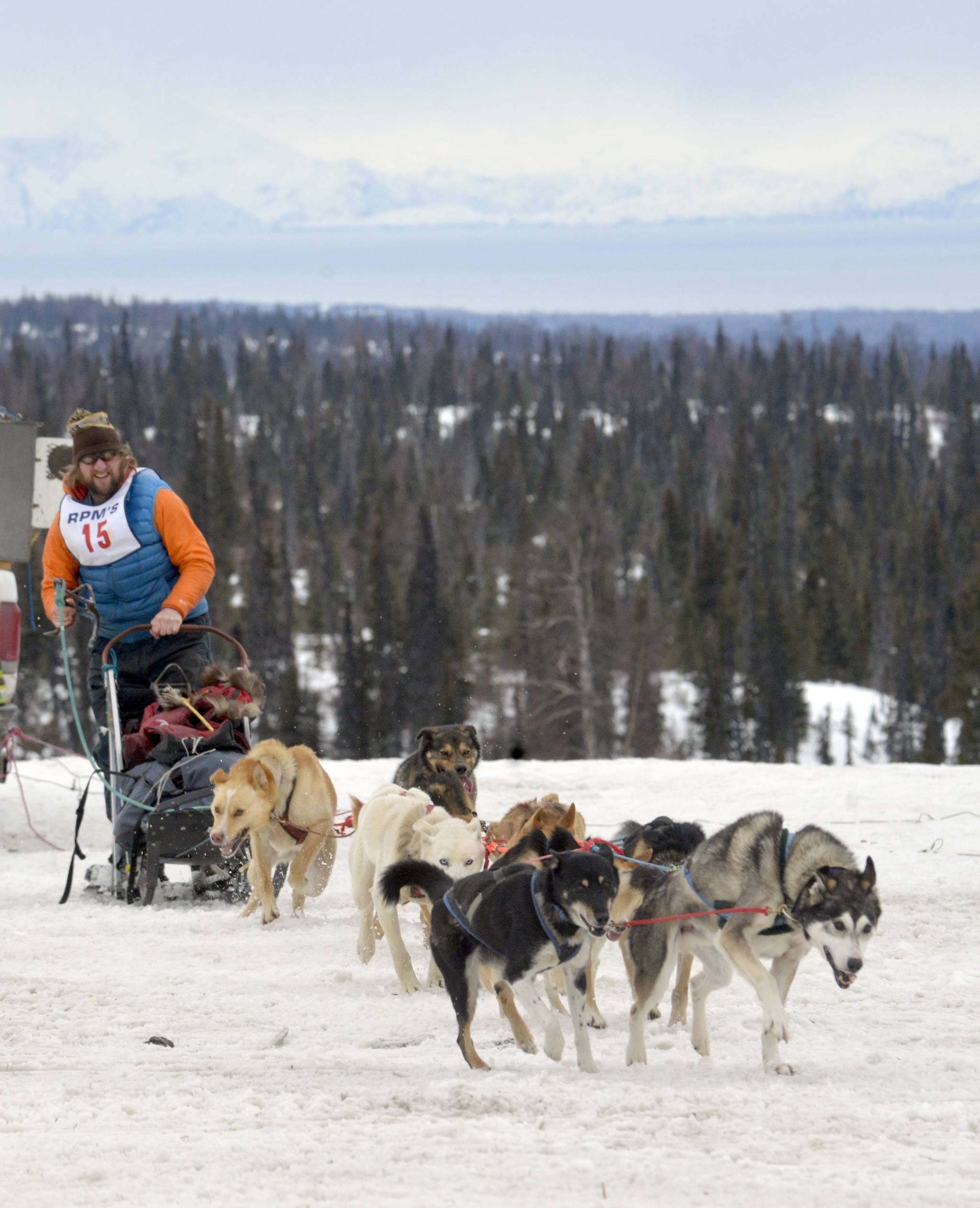 Musher Gus Guenther takes off from the starting line of Freddie’s Midnight Run on Saturday, April 1 in Caribou Hills after the race’s shotgun start, where mushers race from their sleeping bags and hook up their dogs before starting on the trail. (Kat Sorensen/Peninsula Clarion).