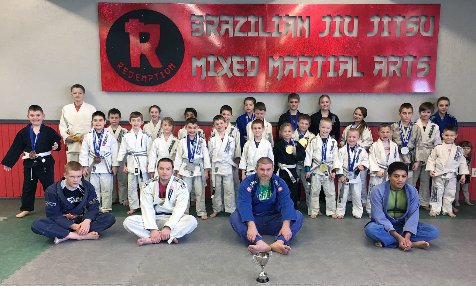 Above is the kids Brazilian Jiu-Jitsu team from Redemption MMA which tied for second place at state: William Bogart, Danny Bennett, Trenton Blume, Carter Norman, Richard Green, Lauren Chircop, Addy Nordwall, Elijah Fulk, Elias Fulk, Charisma Fulk, Hudson Link, Owen Payne, Anthony Payne, Noah Payne, Avery Medina, Sebastian Duyck, Logan Duyck, Levi Forest, Mason Snyder, Nathan Cox, Jacob Cox, Connor Kniceley-John, Milo Bogart, Cali Bennett and Colette Kolesar. Coaches in front from left to right are Sean Babitt, Jacob Montgomery, Redemption Head BJJ coach George Grossman and Adam McClure. (Photo provided by Redemption MMA)