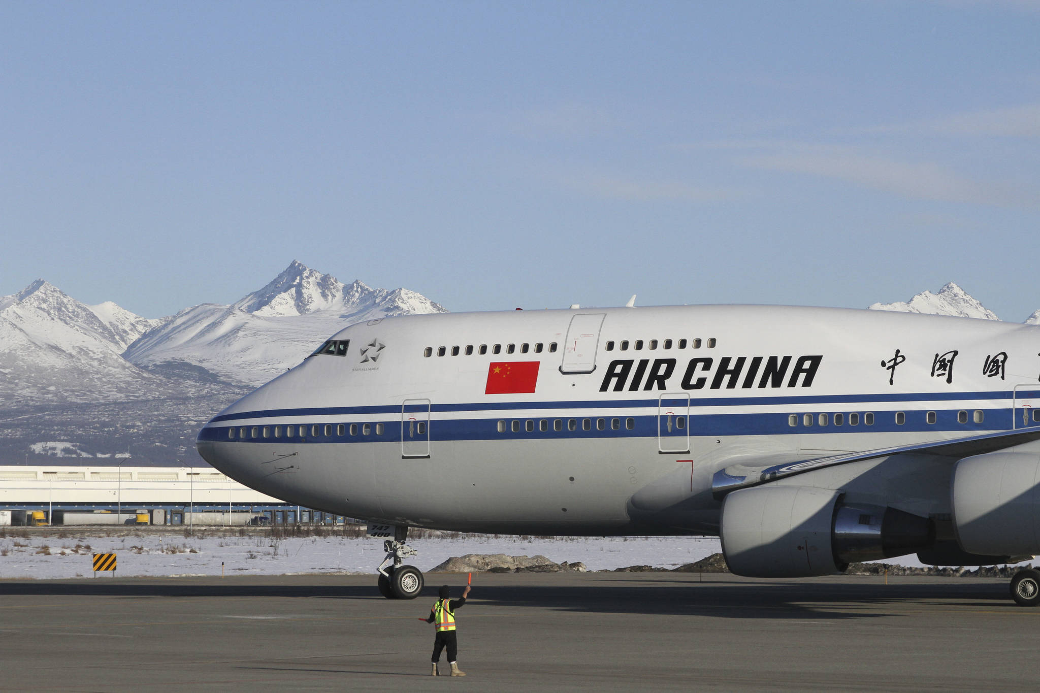 The plane carrying Chinese President Xi Jinping taxies to a stop with the snow-capped Chugach Mountains providing a backdrop Friday, April 7, 2017, in Anchorage, Alaska. During the refueling stop, Xi planned a little sightseeing and a meeting and dinner with Alaska Gov. Bill Walker after spending time earlier in the day with President Donald Trump in Florida. (AP Photo/Mark Thiessen)