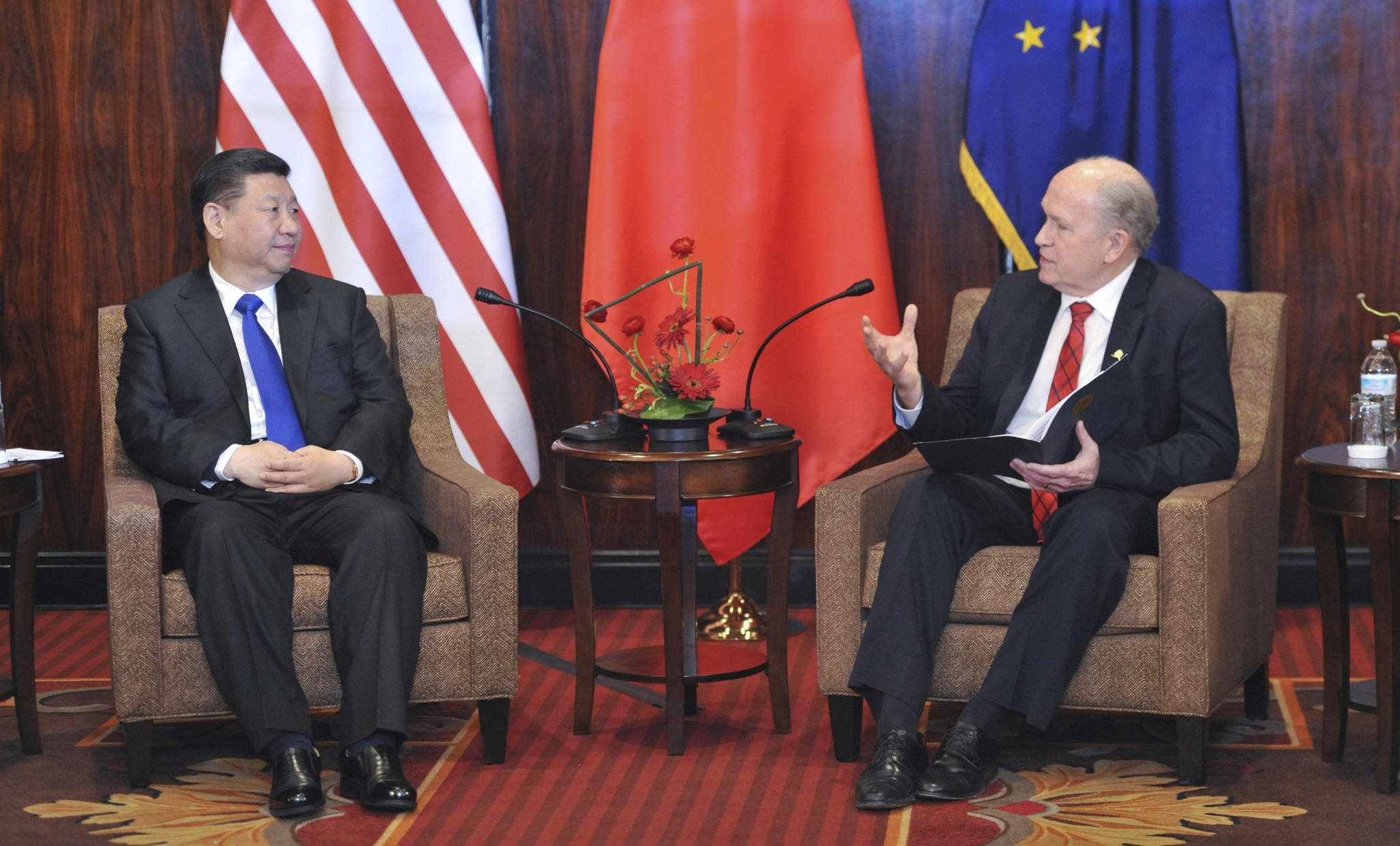 Chinese President Xi Jinping, left, listens to Alaska Governor Bill Walker at a meeting Friday April 7, 2017, in Anchorage, Alaska. Xi requested time with Gov. Walker Friday night as the Chinese delegation’s plane made a refueling stop in Alaska’s largest city following meetings with President Donald Trump in Florida. (AP Photo/Michael Dinneen)