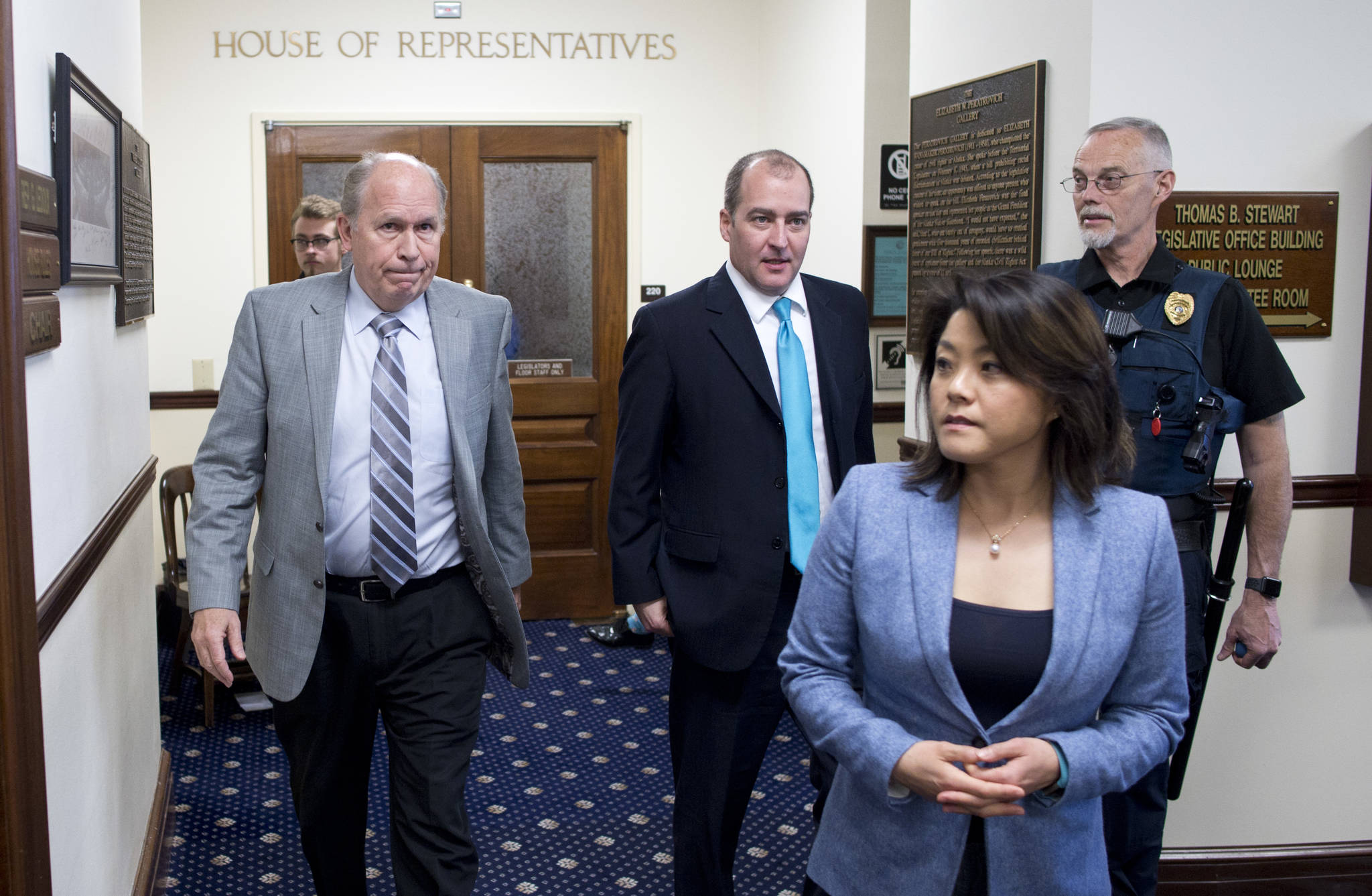 Gov. Bill Walker leaves the gallery of the Alaska House of Representatives with his legislative liaison Darwin Peterson, center, and Communication Director Grace Jang after watching the House passed its version of Senate Bill 26 on Wednesday. (Michael Penn/Juneau Empire)