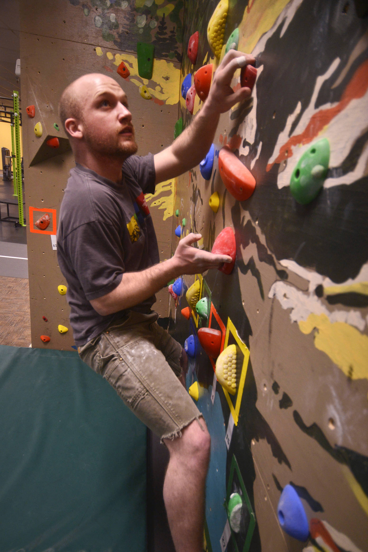 John Walker makes his way through a bouldering route on River City Wellness Center’s new climbing wall on Saturday, April 8, 2017 in Soldotna, Alaska.