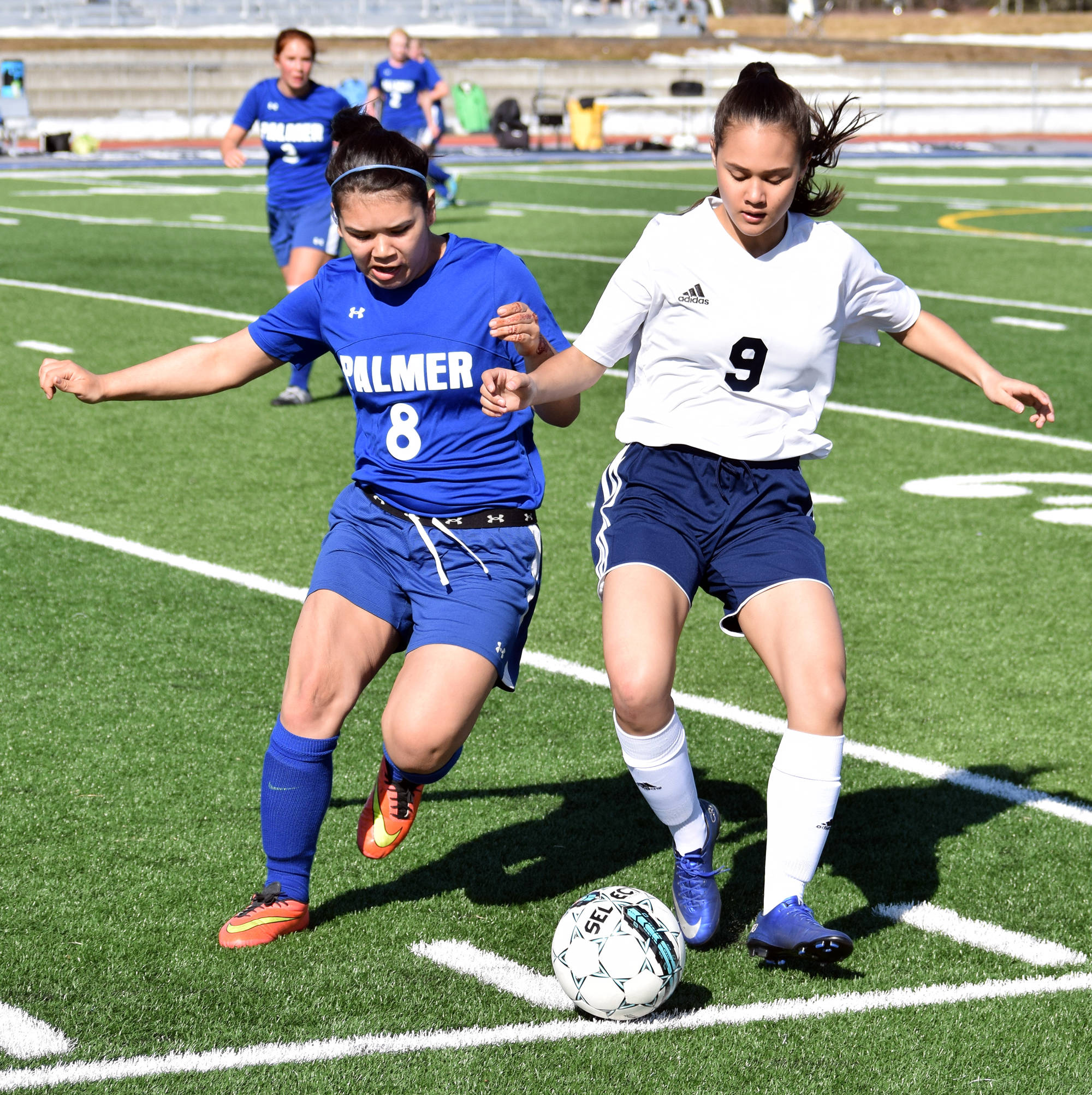 Soldotna freshman Faith Glassmaker (9) fights for possession against Palmer’s Emma Obeso Friday afternoon at Justin Maile Field in Soldotna. (Photo by Joey Klecka/Peninsula Clarion)