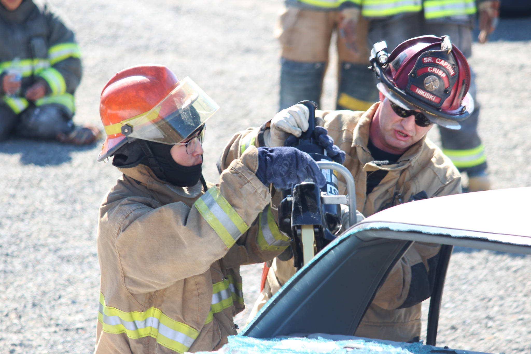 Steven Jacob, 19, from the Kuskokwim Learning Academy, practices using the jaws of life on a car with the help of instructor Bryan Crisp of the Nikiski Fire Department (right) on Thursday, April 20, 2017 at the department’s Station No. 2 in Nikiski, Alaska. Jacob and several other Western Alaska students spent the week getting basic firefighter training through Excel Alaska’s Camp Kick Ash. (Megan Pacer/Peninsula Clarion)