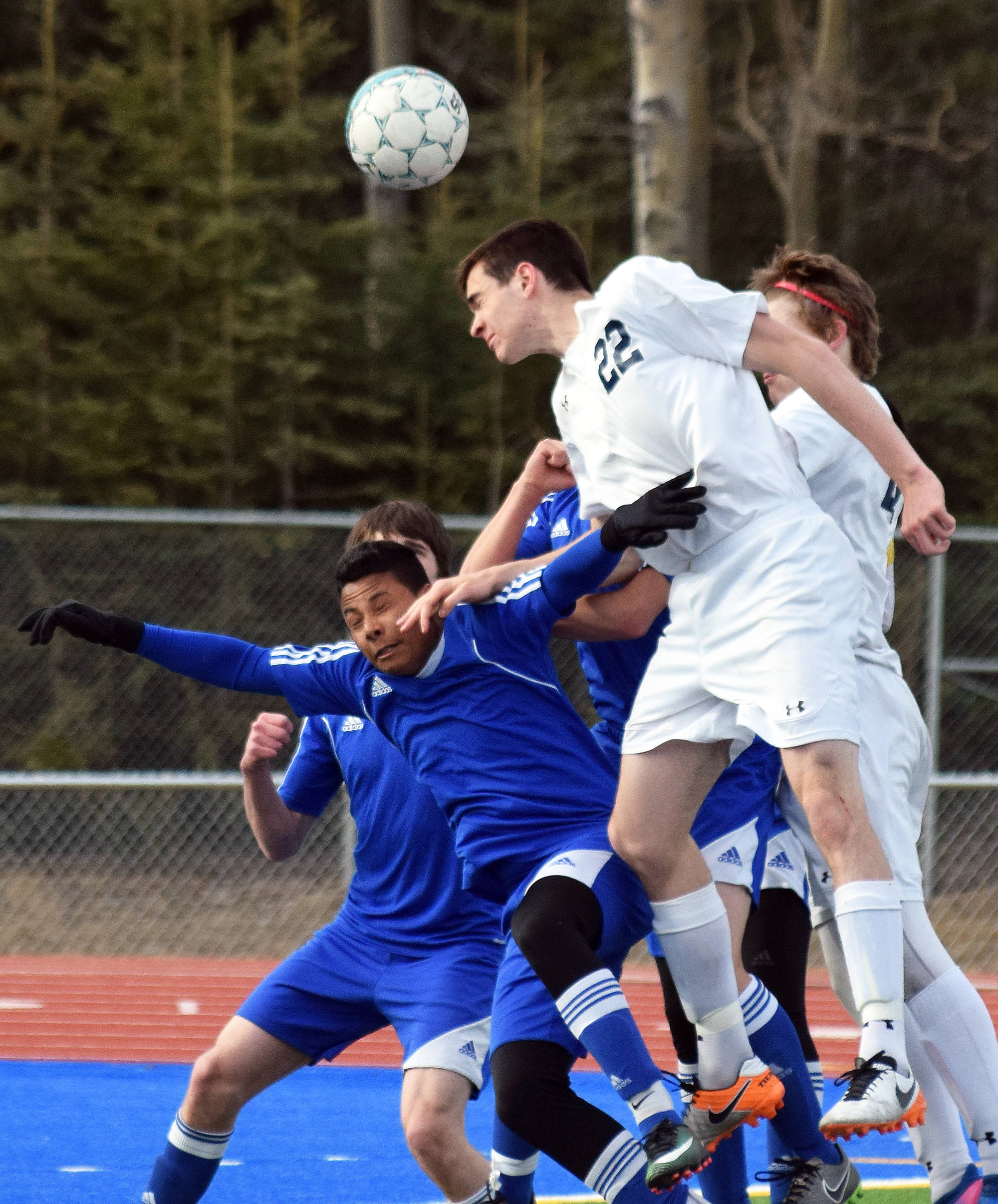 Soldotna’s Sam McElroy (22) gets his head on a corner kick against Kodiak Friday at Justin Maile Field in Soldotna (Photo by Joey Klecka/Peninsula Clarion)