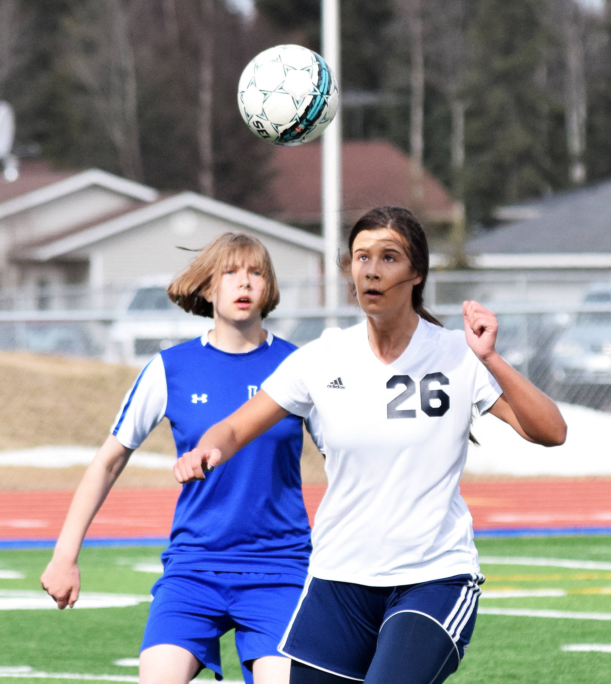 Soldotna’s Whitney Wortham heads the ball in front of Kodiak’s Cassie Scherler Friday at Justin Maile Field in Soldotna (Photo by Joey Klecka/Peninsula Clarion)
