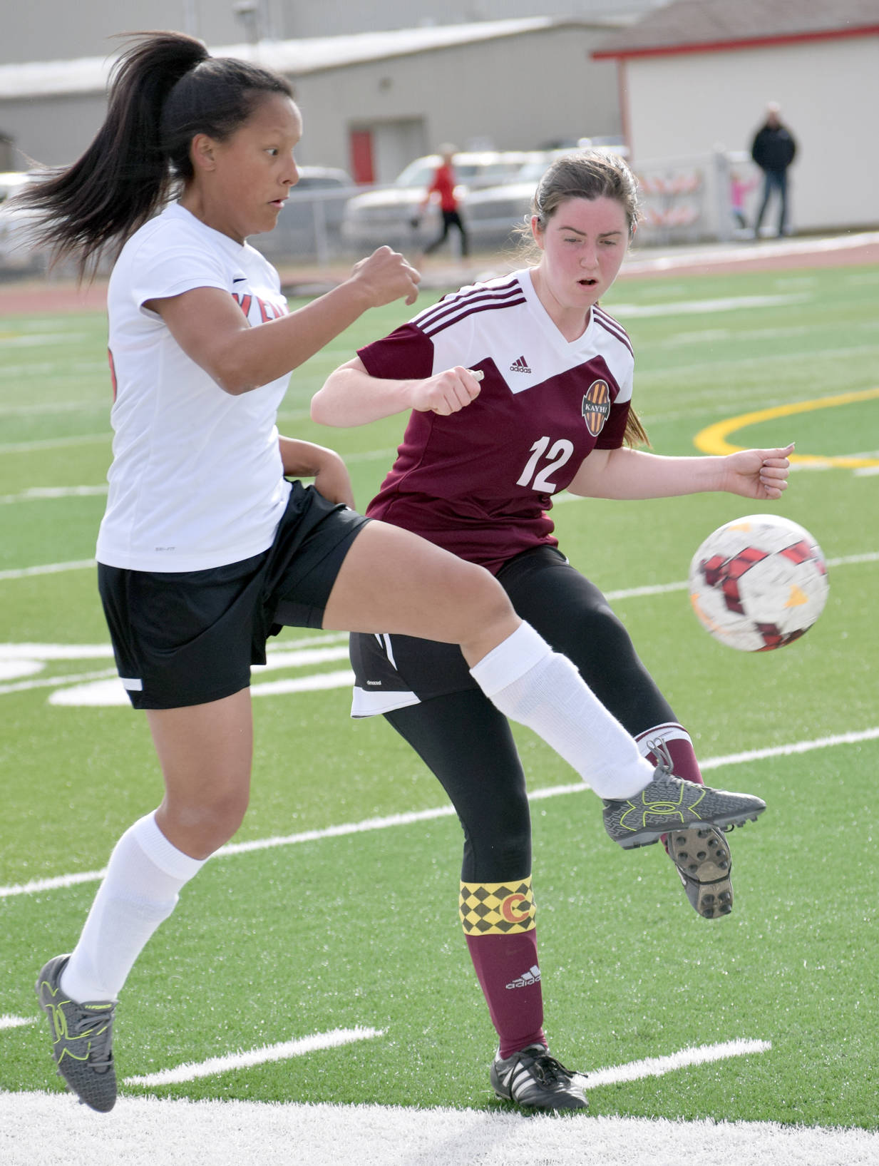 Kenai Central’s Lexy Carrasco at Ketchikan’s Cameron Edwards battle for the ball Wednesday, April 26, 2017, at Kenai Central High School. (Photo by Jeff Helminiak/Peninsula Clarion)