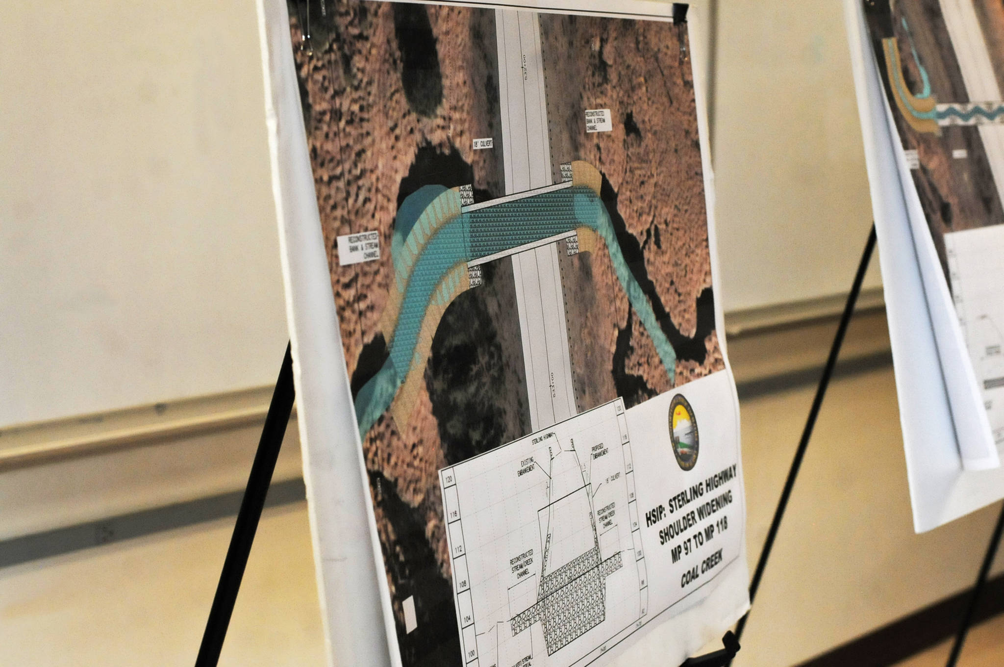 Maps of proposed culvert improvements on several Kasilof-area streams stand in a multipurpose room at Tustumena Elementary School during an Alaska Department of Transportation and Public Facilities open house on a proposed safety improvement project on the Sterling Highway between Soldotna and Clam Gulch on Wednesday in Kasilof. The project, scheduled for summer 2018 and 2019, will include widened shoulders, improved signage, a safety edge and culvert replacements, among other improvements. (Elizabeth Earl/Peninsula Clarion)
