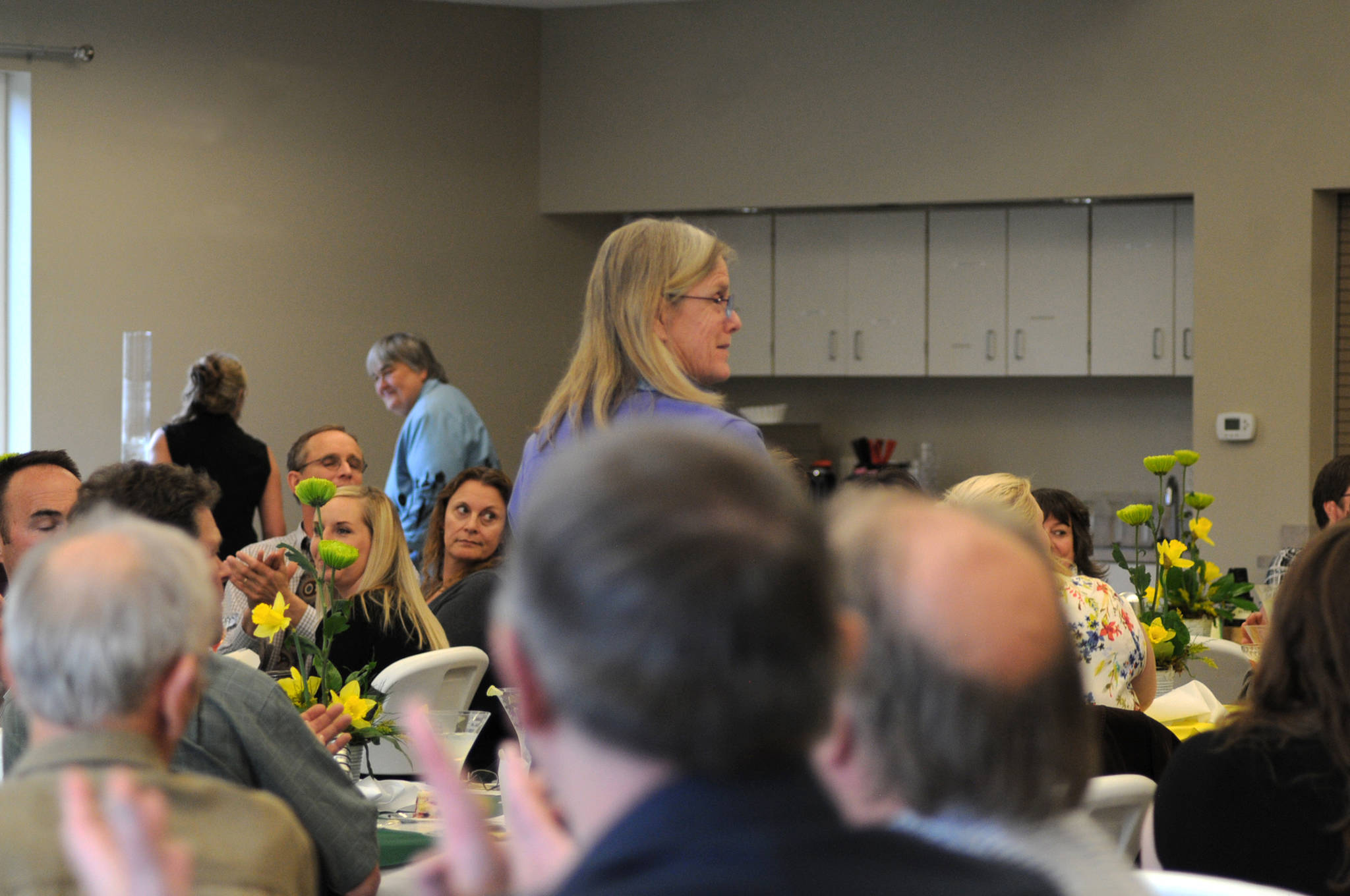 Penny Vadla, a former winner of the BP Teachers of Excellence recognition, stands to applause at the annual dinner recognizing the 2017 winners on Thursday, April 287, 2017 in Soldotna, Alaska. BP recognized five teachers from around the Kenai Peninsula Borough School District for excellence in teaching with certificates, $500 gift cards and $500 donations to their schools. (Elizabeth Earl/Peninsula Clarion)