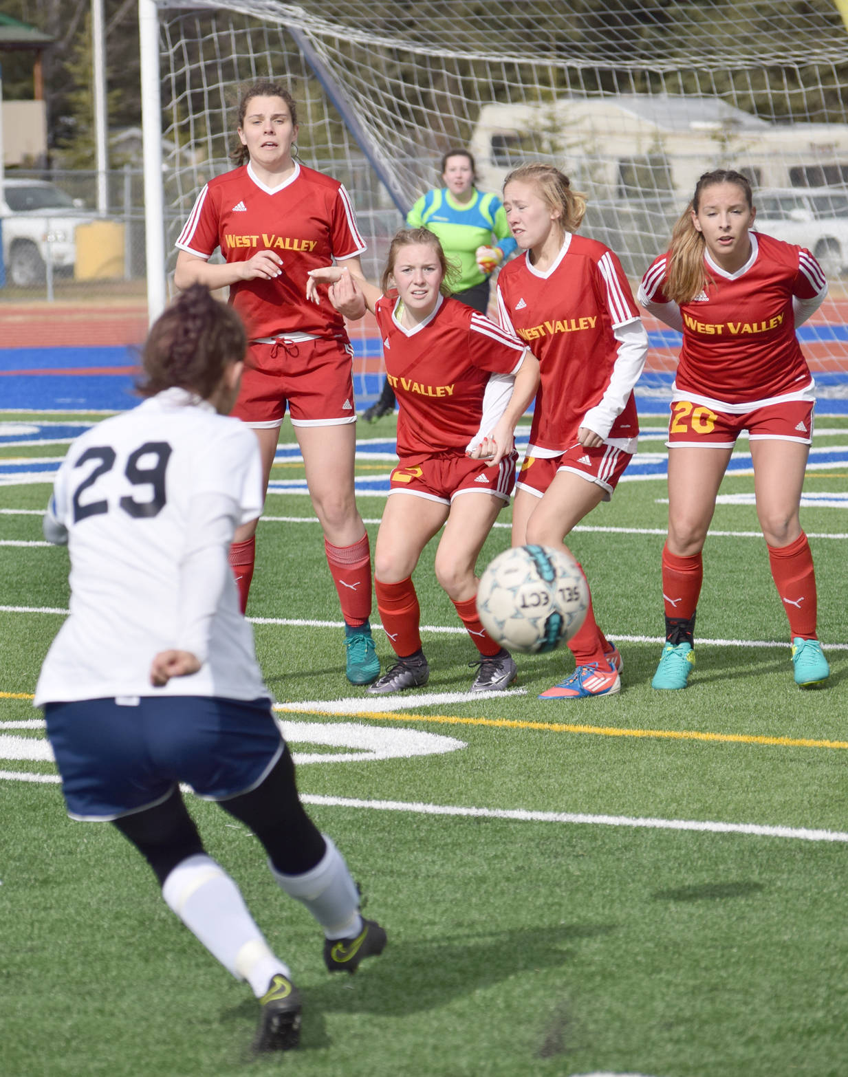 Soldotna’s Abi Tuttle kicks into the West Valley wall of Hannah Olsen, Riley Baumgartner, Kennedy Atlee and Tarryn Clark, backed by goalie Kaleigh Sparks, Wednesday, April 28, 2017, at Soldotna High School. The shot went just wide. (Photo by Jeff Helminiak/Peninsula Clarion)