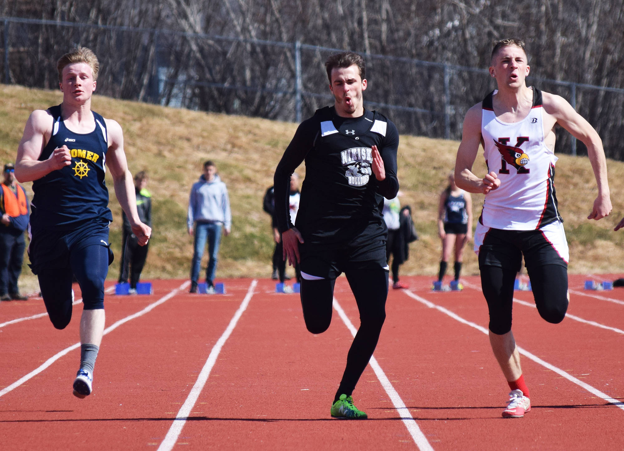 Nikiski junior Isaac Averill races to a victory in the boys 100-meter sprint alongside Teddy Croft of Homer (left) and Josh Jackman of Kenai Central (right) Saturday at the Homer Invite at Homer High School. (Photo by Joey Klecka/Peninsula Clarion)