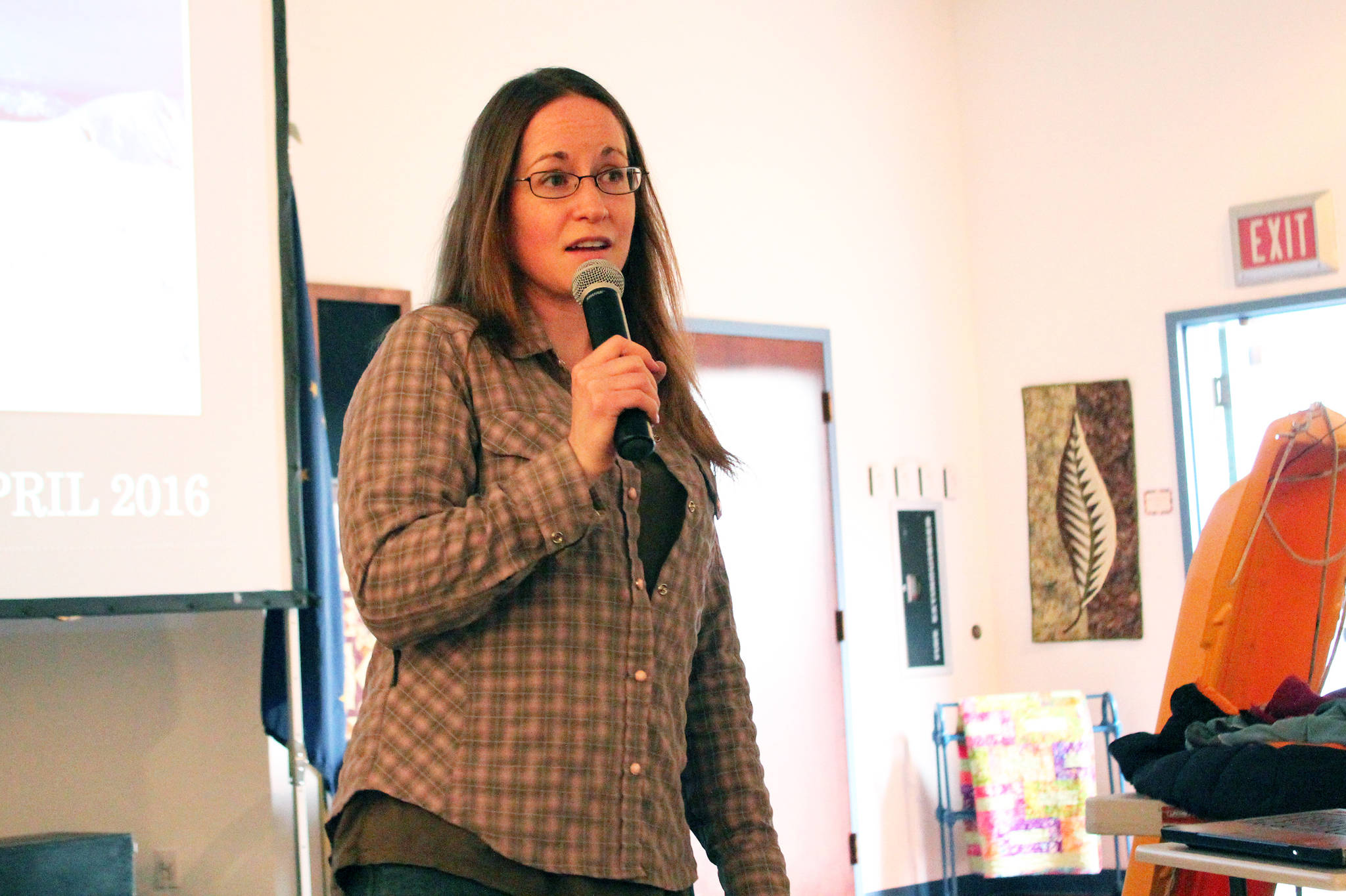 KDLL General Manager Jenny Neyman speaks to a crowd of people about the five days she spent stuck up on the Harding Icefield last year with fellow Soldotna resident Chris Hanna during a presentation Friday, April 28, 2017 at the Kenai Chamber of Commerce and Visitor Center in Kenai, Alaska. The evening was part of “Adventure Talks,” a KDLL series that will include on-air interviews with Kenai Peninsula residents about their adventures, as well as public presentations the last Friday of the month at the visitor center. (Megan Pacer/Peninsula Clarion)