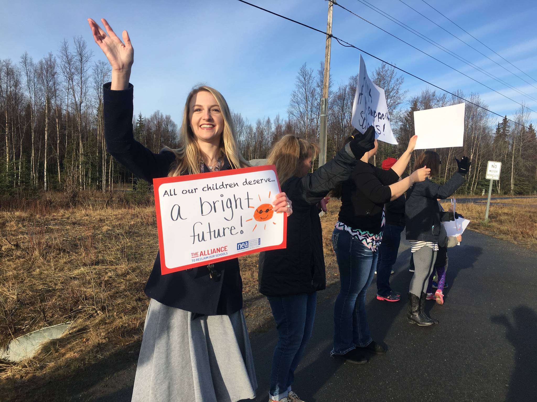 Callie Giordano, a teacher at Mountain View Elementary, participated in a rally on Tuesday, May 2, 2017 at the corner of Swires Road and the Kenai Spur Highway to support fully funding education. (Kat Sorensen/Peninsula Clarion)