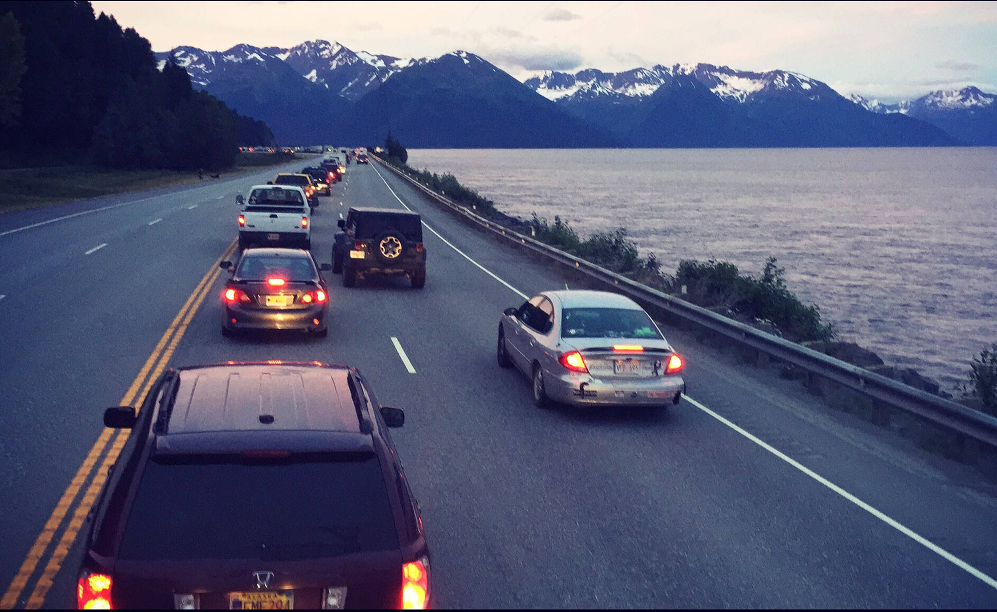 This photo taken July 3, 2015 shows cars lined up on the Seward Highway along the Turnagain Arm in after a fatal accident in which a trooper vehicle struck and killed a motorcyclist it was pursuing closed the highway for several hours. Troopers have reduced their coverage of a stretch from about mile 75 of that highway to south of McHugh Creek due to budget cuts. (Ben Boettger/Peninsula Clarion)