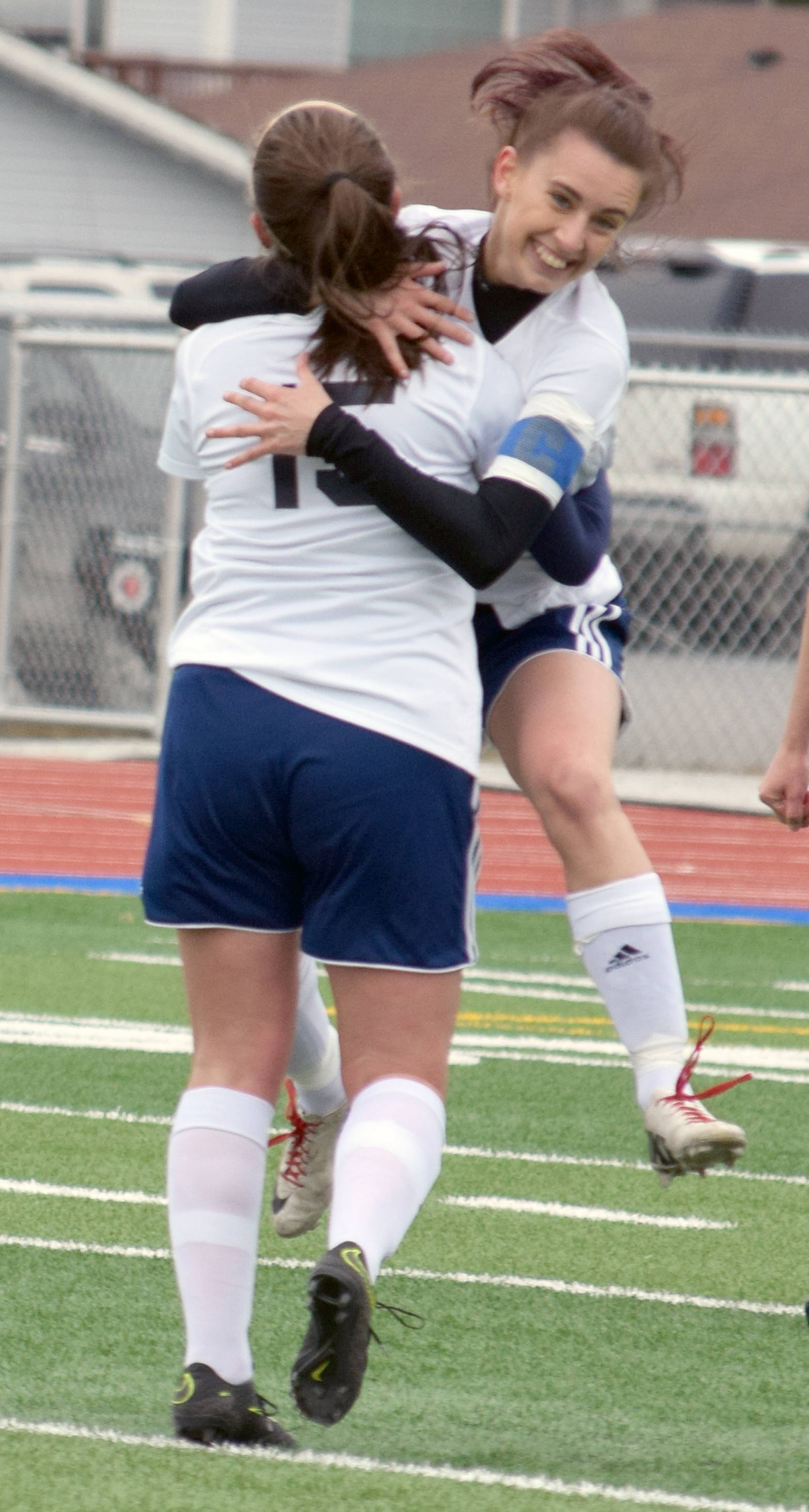 Soldotna Abi Tuttle jumps into the arms of Elena Bramante after scoring the game-winning goal against Kenai Central on Tuesday at Soldotna High School. (Photo by Jeff Helminiak/Peninsula Clarion)