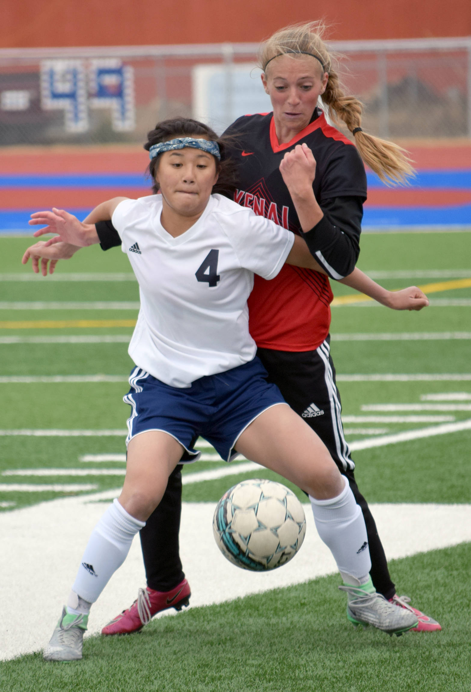 Soldotna’s Meijan Leaf shields the ball from Kenai Central’s Samantha Morse on Tuesday, May 2, 2017, at Soldotna High School. (Photo by Jeff Helminiak/Peninsula Clarion)