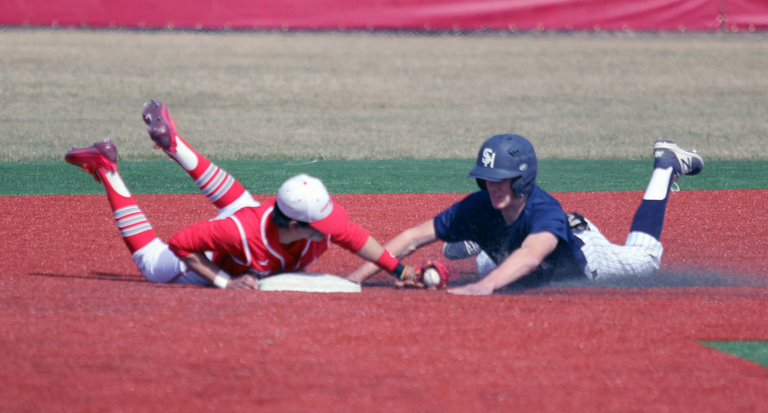 Soldotna’s Cody Quelland slides into second base beating the tag attempt by Wasilla shortstop Balas Buckmaster during Wasilla’s 12-9 win over the Stars on Saturday afternoon at Wasilla High School. (Photo by Jeff Helminiak/Peninsula Clarion)