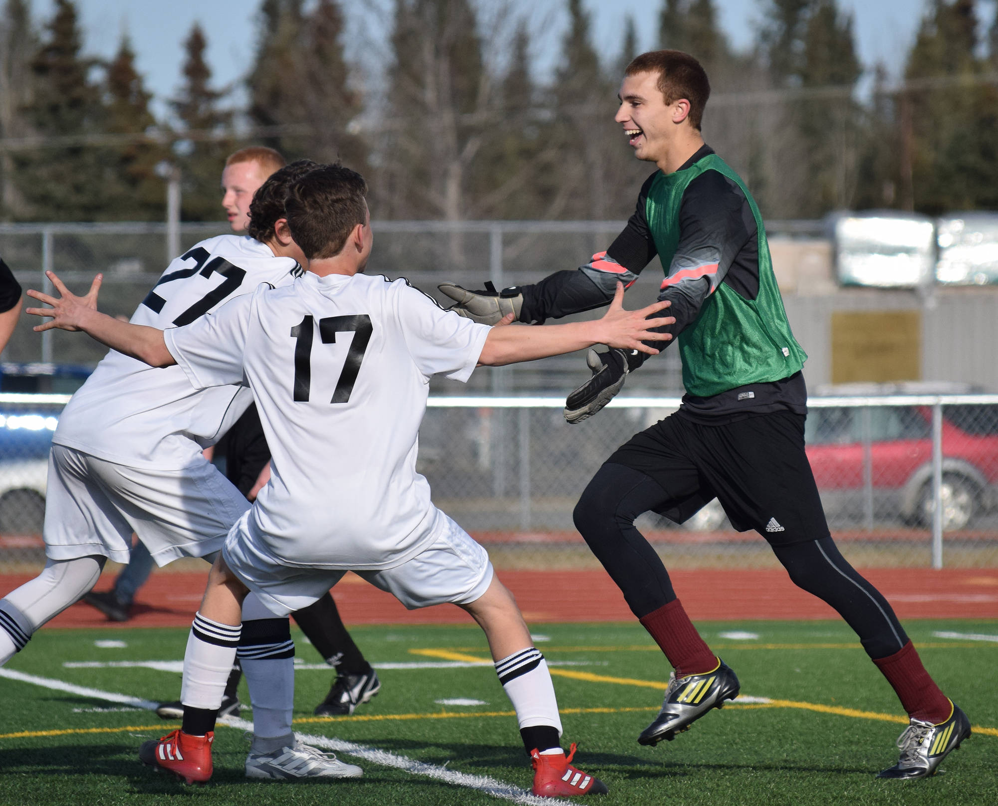 Kenai Central goalkeeper Tristan Landry celebrates with teammates after scoring on a penalty kick against Nikiski Friday afternoon at Ed Hollier Field in Kenai. (Photo by Joey Klecka/Peninsula Clarion)