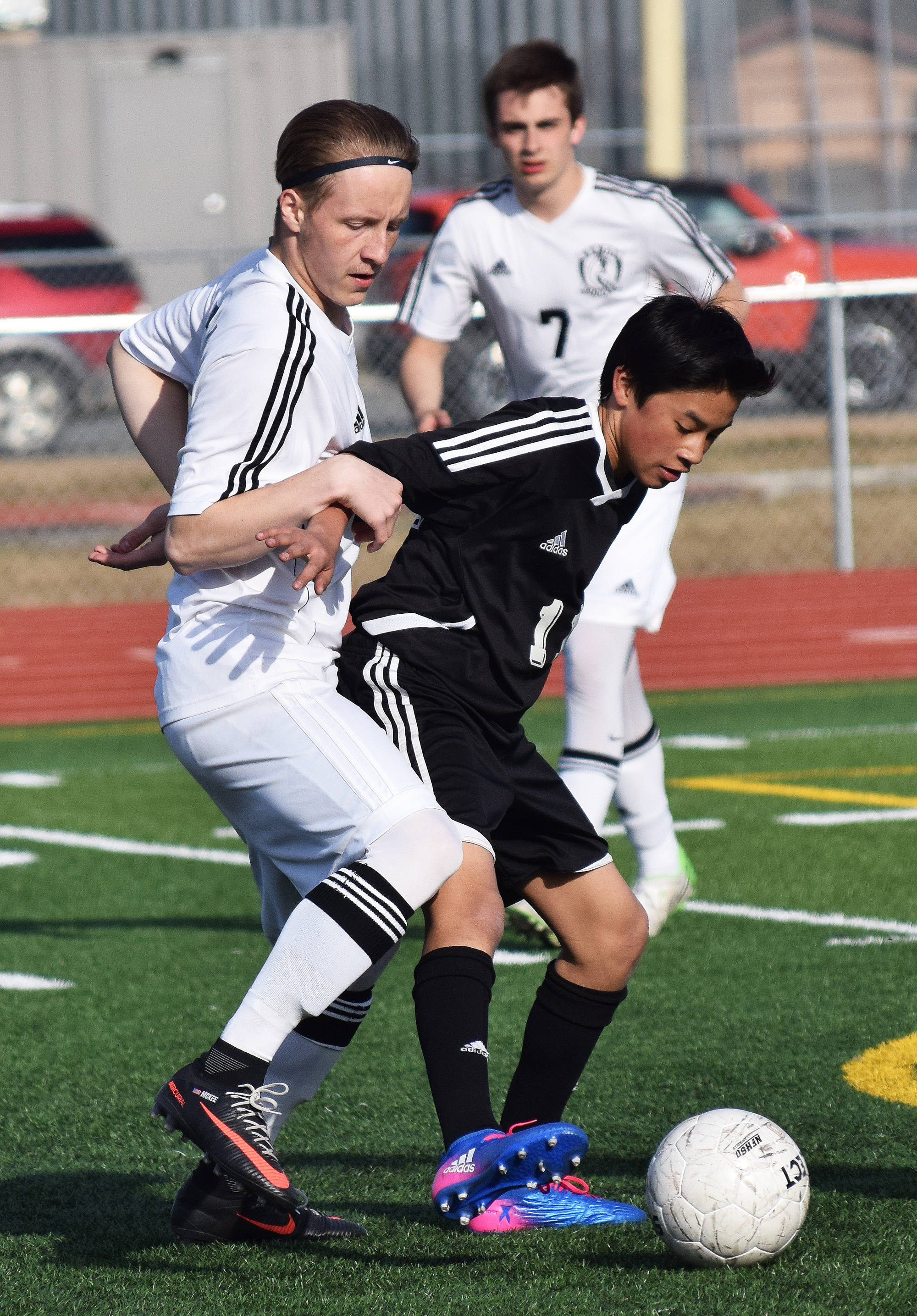 Kenai Central’s Riley McKee (left) and Nikiski’s Martin Cox battle for possession of the ball Friday afternoon at Ed Hollier Field in Kenai. (Photo by Joey Klecka/Peninsula Clarion)