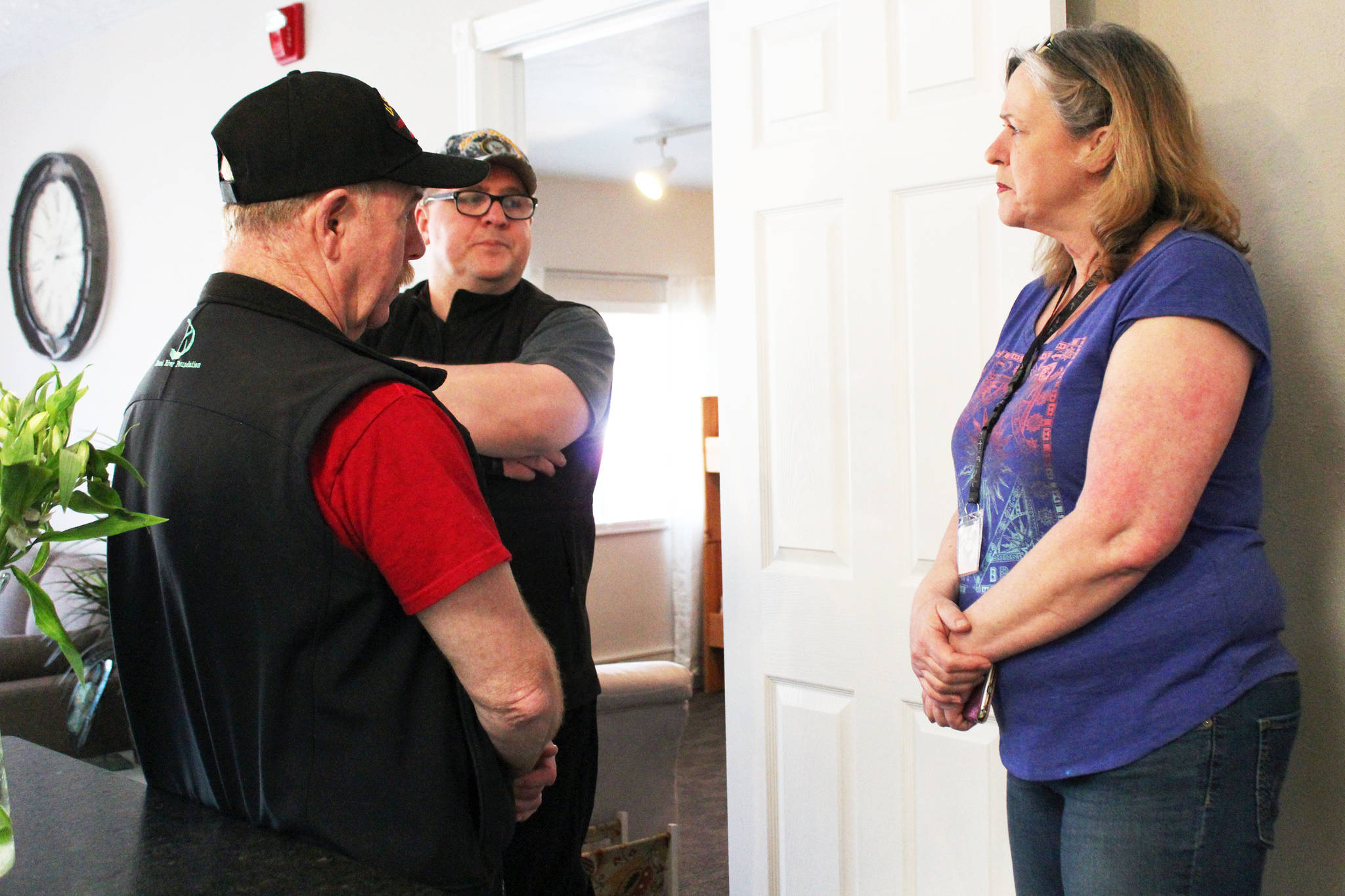 Kristina Fitzgerald, resident manager of Freedom House in Soldotna, talks with John Walker and Mike Meredith of the VFW during the sober living home’s open house Friday, May 5, 2017 at the house on Shady Lane in Soldotna, Alaska. Freedom House is an eight-bed, faith-based transitional living home for women recovering from addictions. (Megan Pacer/Peninsula Clarion)