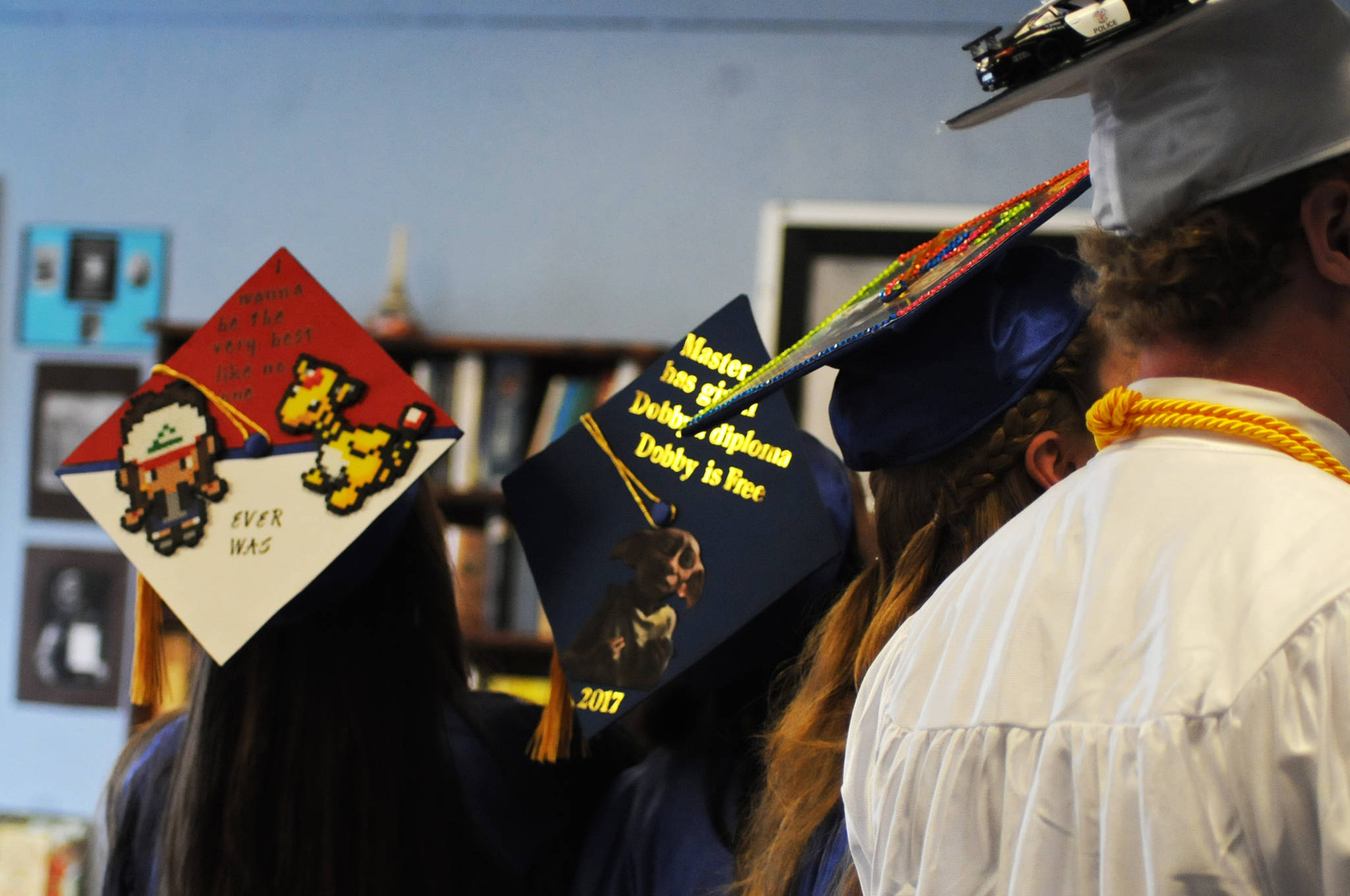 Four of the seven Cook Inlet Academy graduates of 2017 display the creative decorations on their caps before the school’s graduation ceremony Sunday, May 7, 2017 in Soldotna, Alaska. (Elizabeth Earl/Peninsula Clarion)  Four of the seven Cook Inlet Academy graduates of 2017 display the creative decorations on their caps before the school’s graduation ceremony Sunday in Soldotna. (Elizabeth Earl/Peninsula Clarion)
