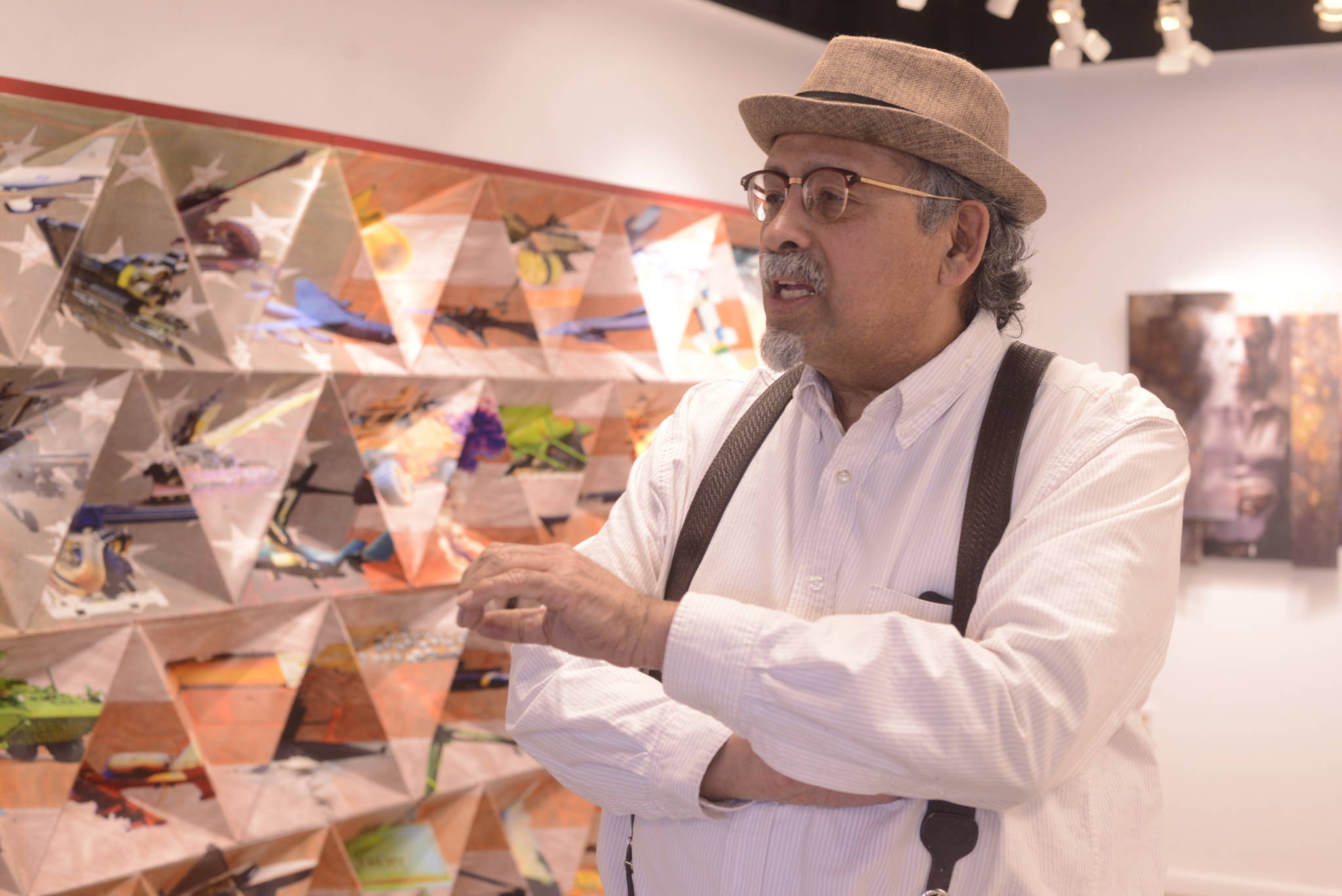 Mariano Gonzales discusses his show “Swimming Upstream” on May 4, 2017 at Kenai Fine Art Center in Kenai. The show will hang until May 27. (Kat Sorensen/Peninsula Clarion)