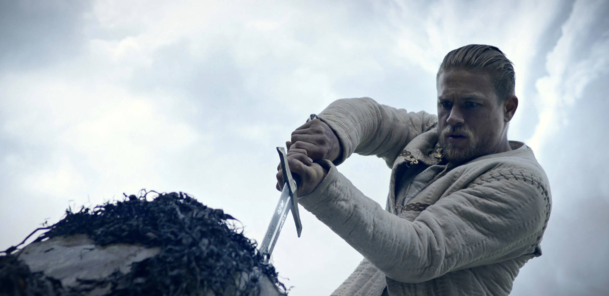 This image released by Warner Bros. Pictures shows Charlie Hunnam in a scene from, “King Arthur: Legend of the Sword.” (Warner Bros. Pictures via AP)