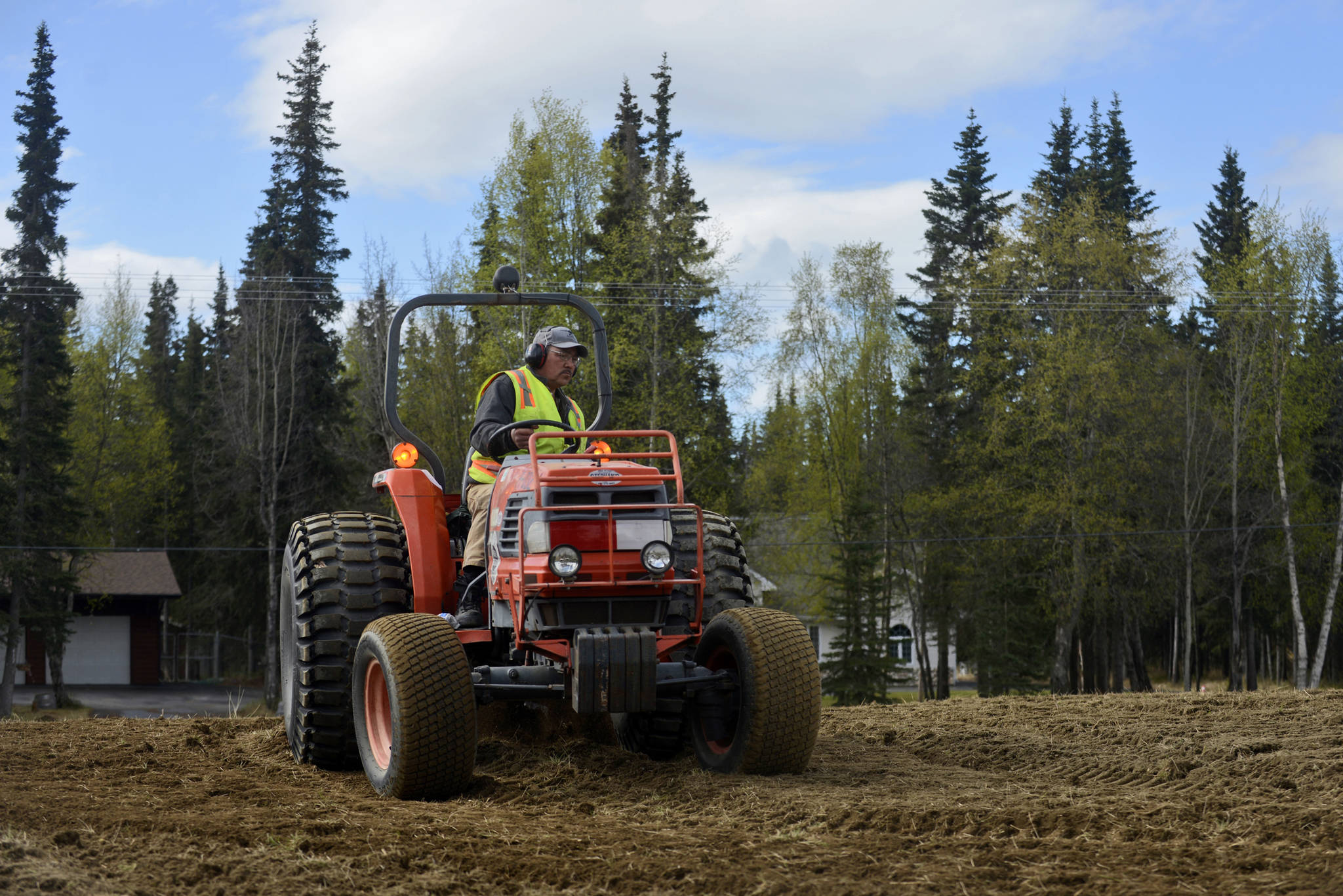 William Konig of Kenai’s Parks and Recreation department tills the Field of Flowers, preparing it to be planted with wildflowers, on Wednesday, May 17 in Kenai. The Field of Flowers is part of a 16 acre city-owned strip known as Lawton Acres, which sits between the Kenai Spur Highway and a neighborhood to the south where residents have been fighting commercial development of the land since the late 1980s. On Monday, many spoke at a Kenai City Council work session about possible resolutions to the dispute.