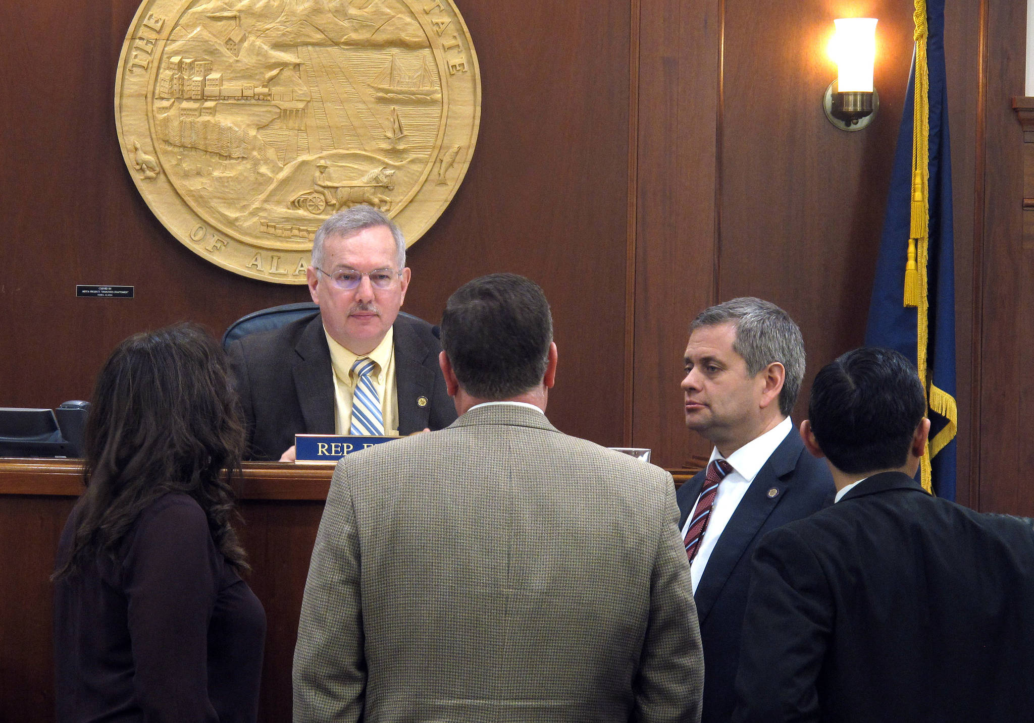 Several Alaska state representatives gather in front of state House Speaker Bryce Edgmon during a break in a House floor session on Wednesday, May 17, 2017, in Juneau, Alaska. (AP Photo/Becky Bohrer)