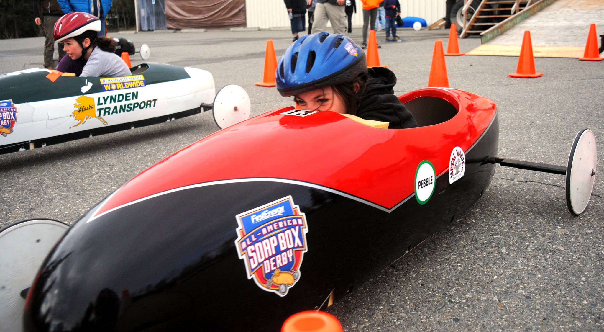 Dustin Hill, of Kenai, races down the track at the All-American Soap Box Derby on Saturday, May 20, 2017 in the Kenai Municipal Rink parking lot in Kenai, Alaska. The Kenai Rotary Club has hosted the derby for ten years and aims to empower local youth through hard work and creativity in designing and building cars, the spirit of competition on race day and sportsmanship and comradery. The derby is the only Soap Box Derby race in Alaska. (Kat Sorensen/Peninsula Clarion)