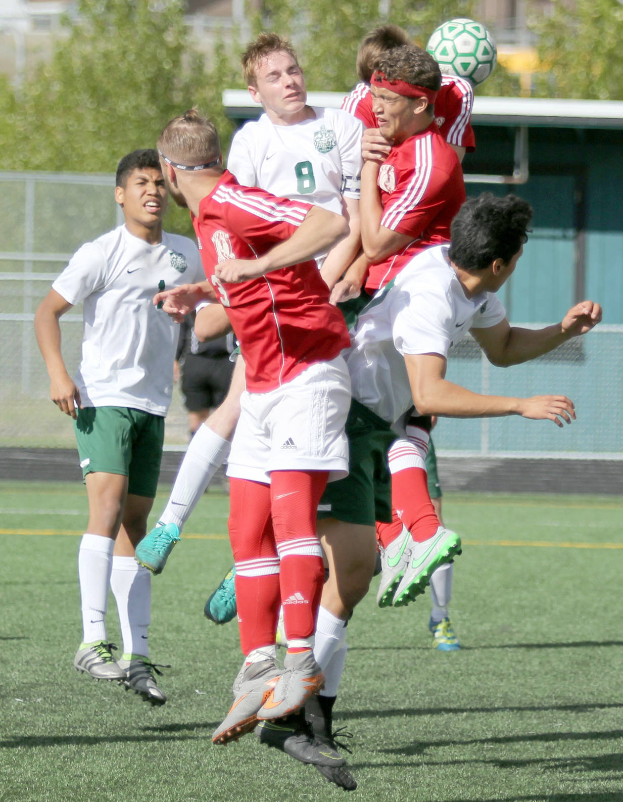 Colony’s Cade Johnstone and Kenai’s Braydon Goodman are among a group of players all going up for a header off a corner kick during Kenai’s 3-1 win over the Knights in the Northern Lights Conference boys title game Saturday, May 20, 2017, at Colony High School. (Photo by Jeremiah Bartz/Frontiersman.com)