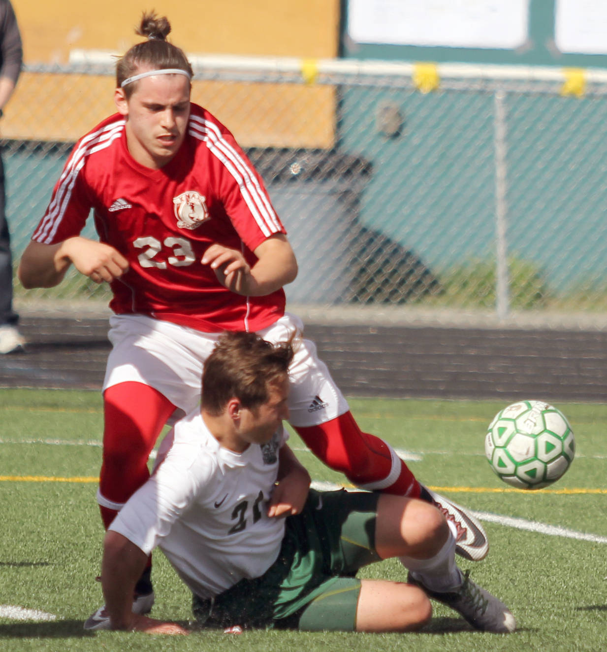 Colony’s Michael Shower slides to knock the ball away from Kenai’s Zack Tuttle during Kenai’s 3-1 win over the Knights in the Northern Lights Conference boys title game Saturday, May 20, 2017, at Colony High. Tuttle scored twice in the win. (Photo by Jeremiah Bartz/Frontiersman.com)