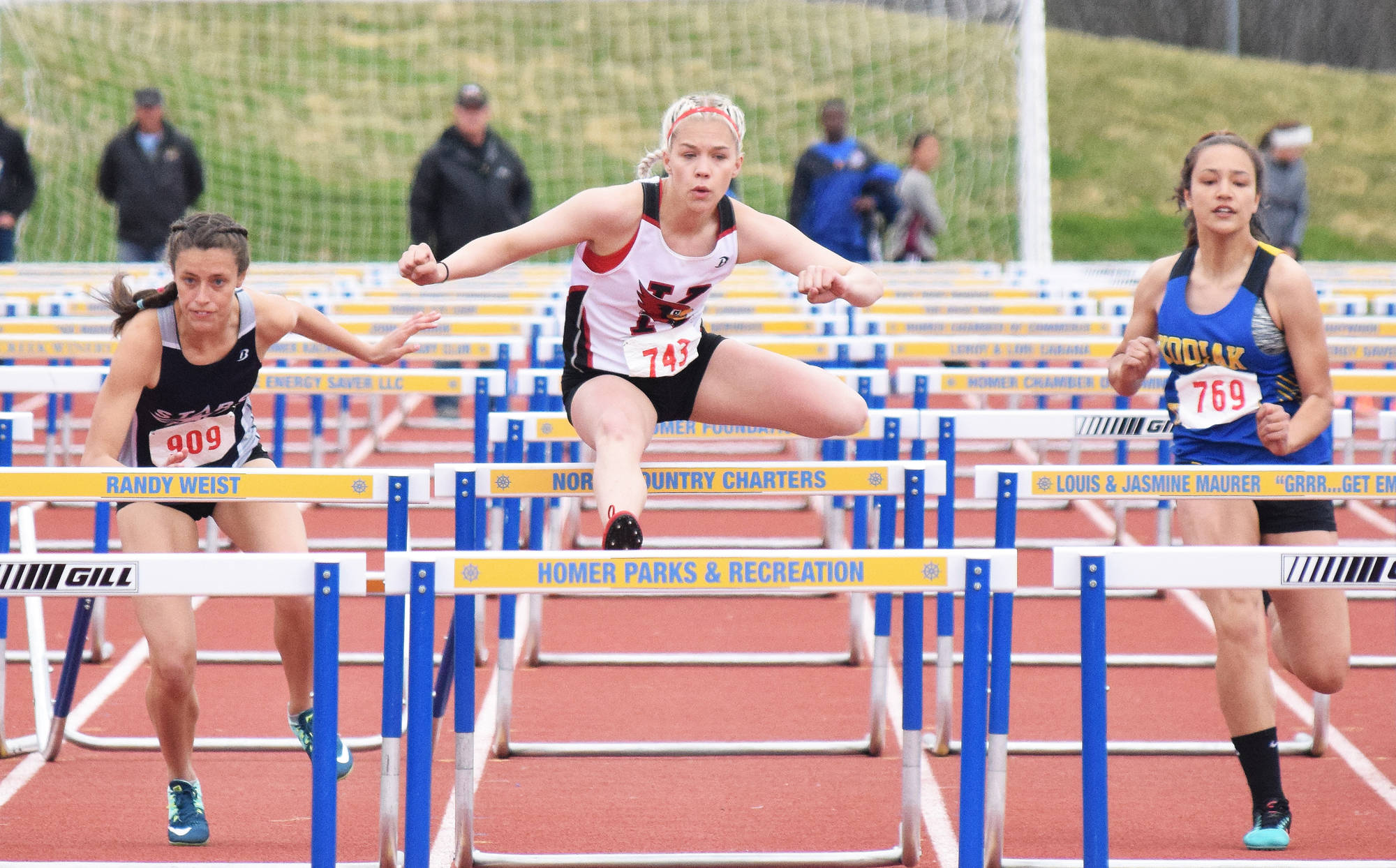 Kenai Central’s Katie Kilfoyle leads the field in the Class 4A girls 100-meter hurdles final Saturday at the Region III track & field championships in Homer. (Photo by Joey Klecka/Peninsula Clarion)