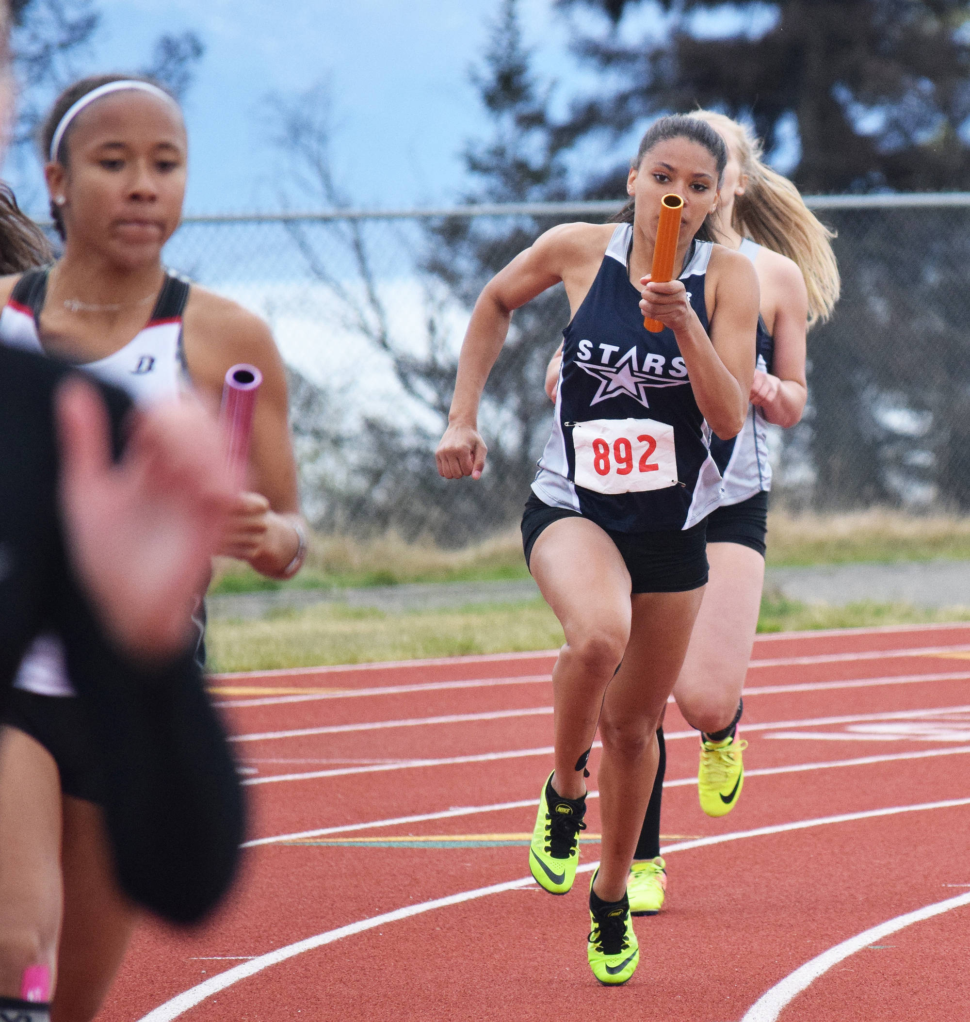 Soldotna’s Brittany Taylor hands the baton off to teammate Tovia Bremond-Hilton in the Class 4A girls 800-meter relay Saturday at the Region III track & field championships in Homer. (Photo by Joey Klecka/Peninsula Clarion)