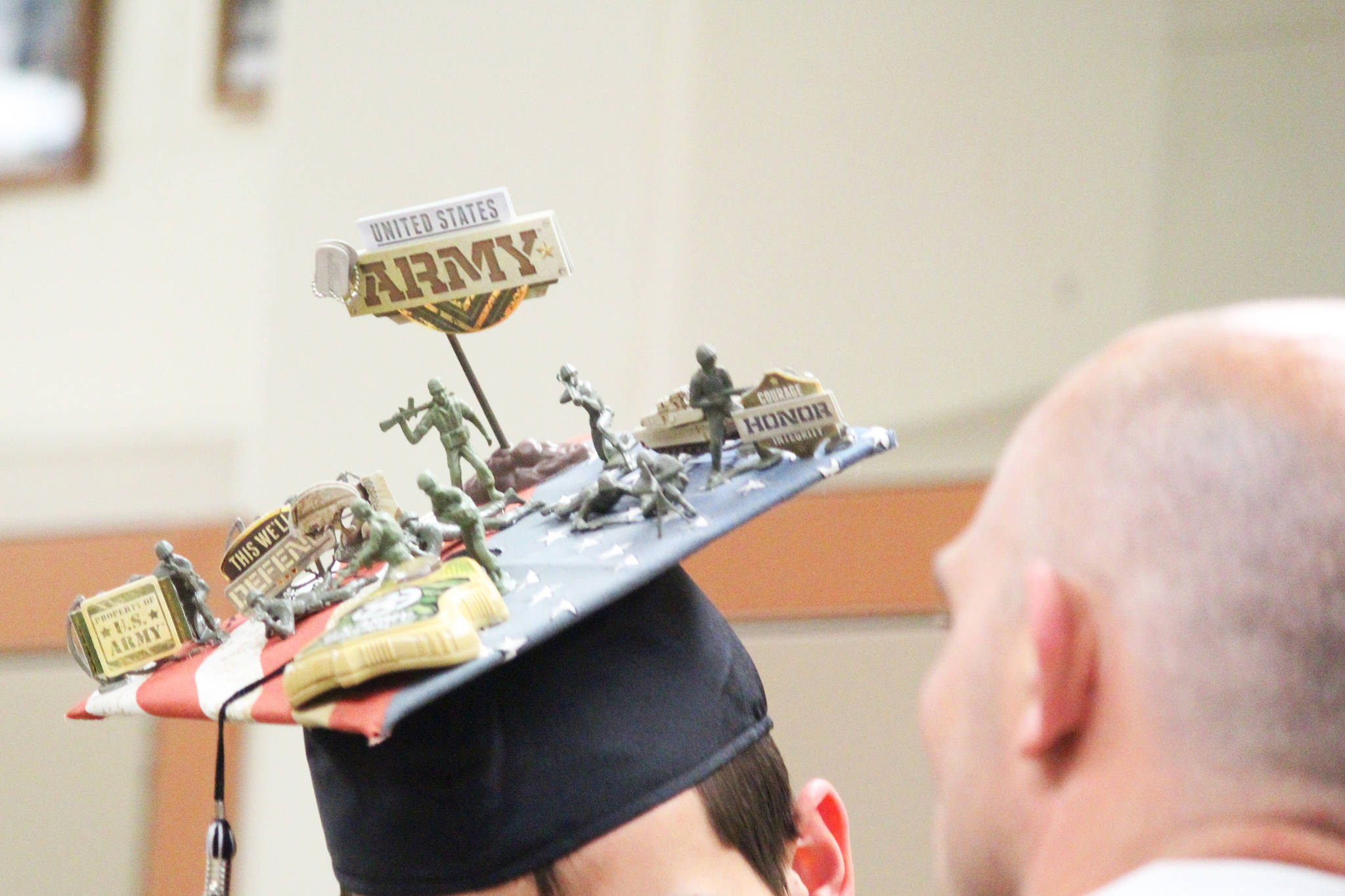Graduates of Nikiski Middle-High School spared no expense when it came to decorating their caps for their Tuesday, May 23, 2017 ceremony at the school in Nikiski, Alaska. Clayton Larson’s hat, pictured here, is adorned to represent his path to the U.S. Army following graduation. (Megan Pacer/Peninsula Clarion)