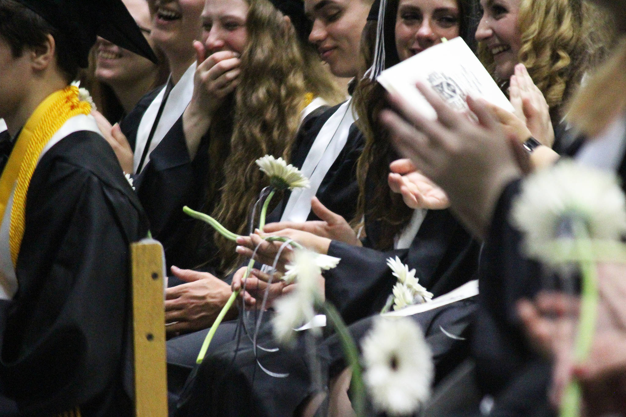 Soon-to-be graduates of Nikiski Middle-High School laugh and cheer during their ceremony Tuesday, May 23, 2017 at the school’s gymnasium in Nikiski, Alaska. (Megan Pacer/Peninsula Clarion)
