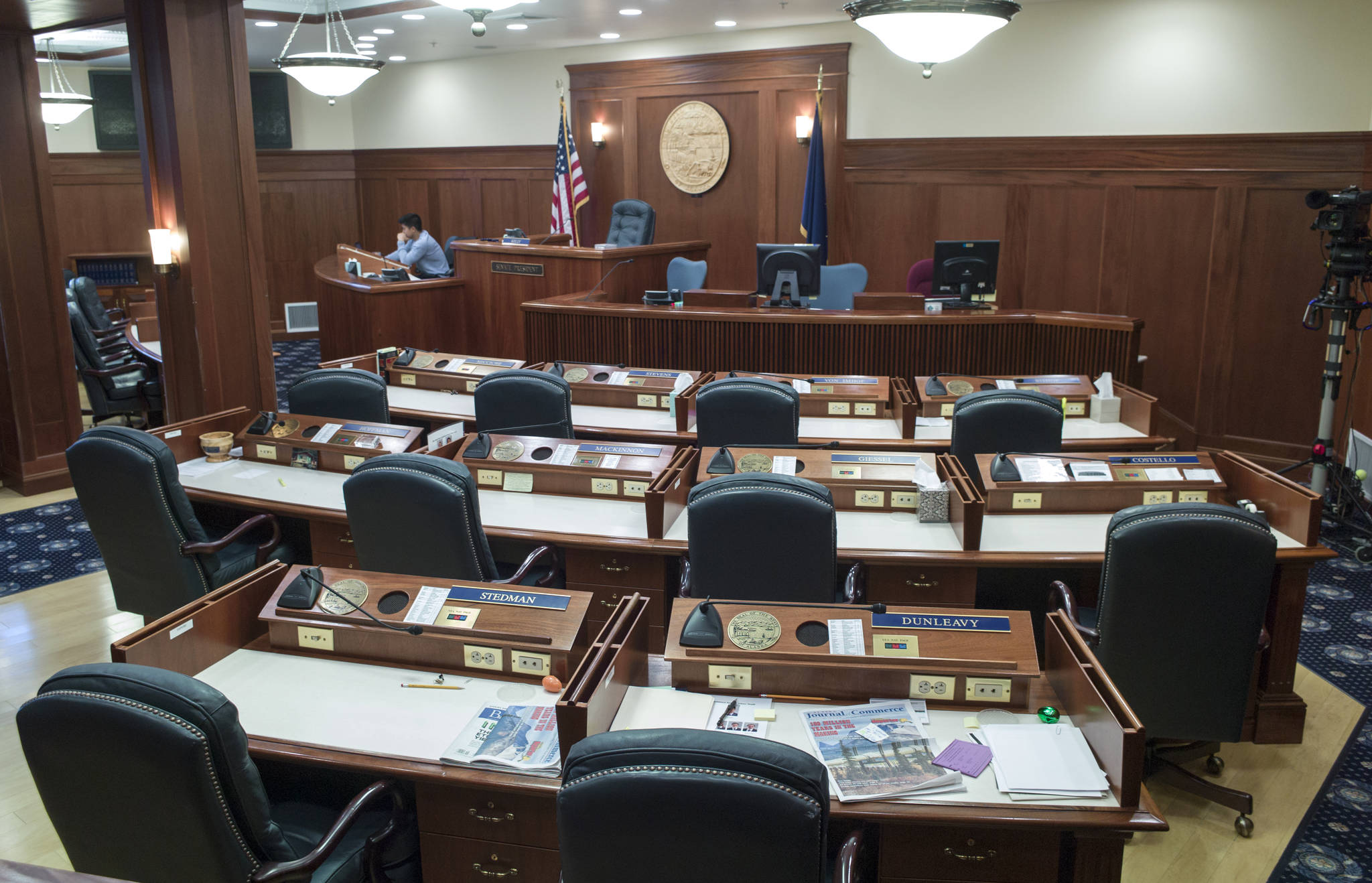 Romorenzo Marasigan, Assistant Sergeant-at-Arms, works by himself in an empty Senate chambers at the Capitol on May 23. After a week of a 30-day special session, nothing has moved and most legislators have headed home for the Memorial Day holiday. (Photo/Michael Penn/Juneau Empire)