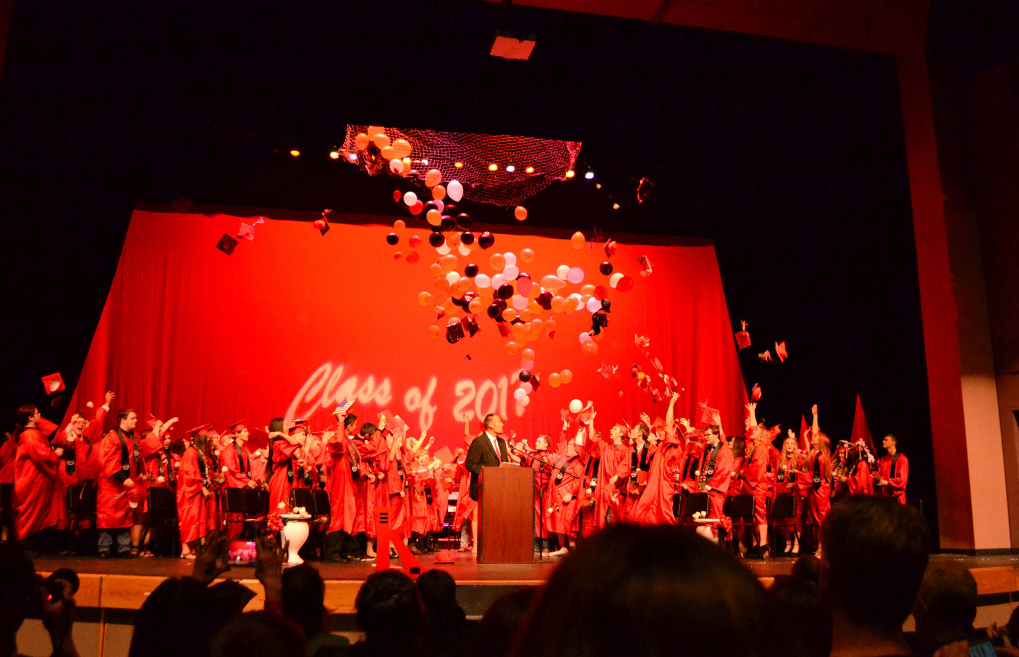 Students in Kenai Central High School’s graduating class of 2017 toss their caps in the air at the end of their commencement ceremony Wednesday, May 24, 2017 at the Renee C. Henderson Auditorium in Kenai, Alaska. (Photo courtesy Beth Ulricksen/Peninsula Clarion)