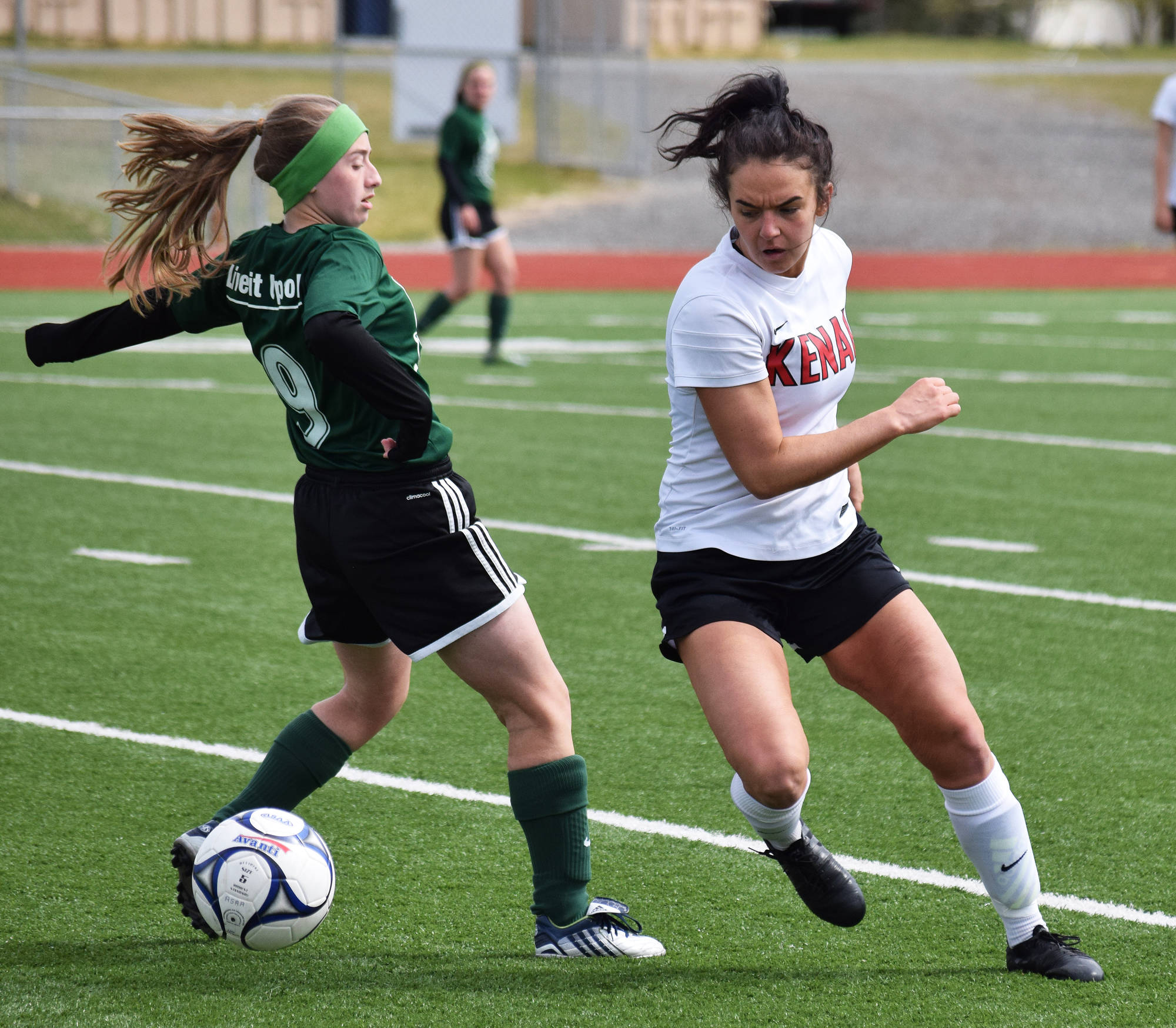 Kenai Central’s Cassi Holmes reverses course against Colony’s Autumn Richardson in a consolation semifinal Friday at the girls state soccer tournament at Eagle River High School. (Photo by Joey Klecka/Peninsula Clarion)