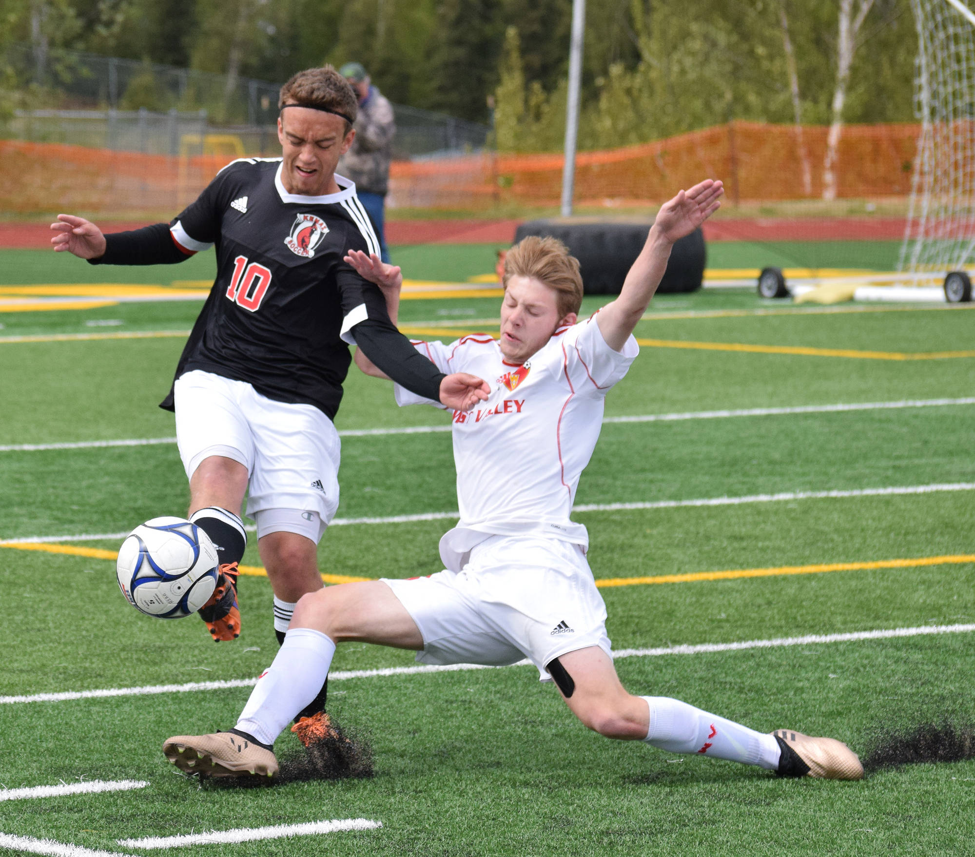 Kenai Central’s Braydon Goodman (10) fights for a loose ball against West Valley’s Shane Gillette in Friday’s state tournament semifinal matchup at Service High School. (Photo by Joey Klecka/Peninsula Clarion)