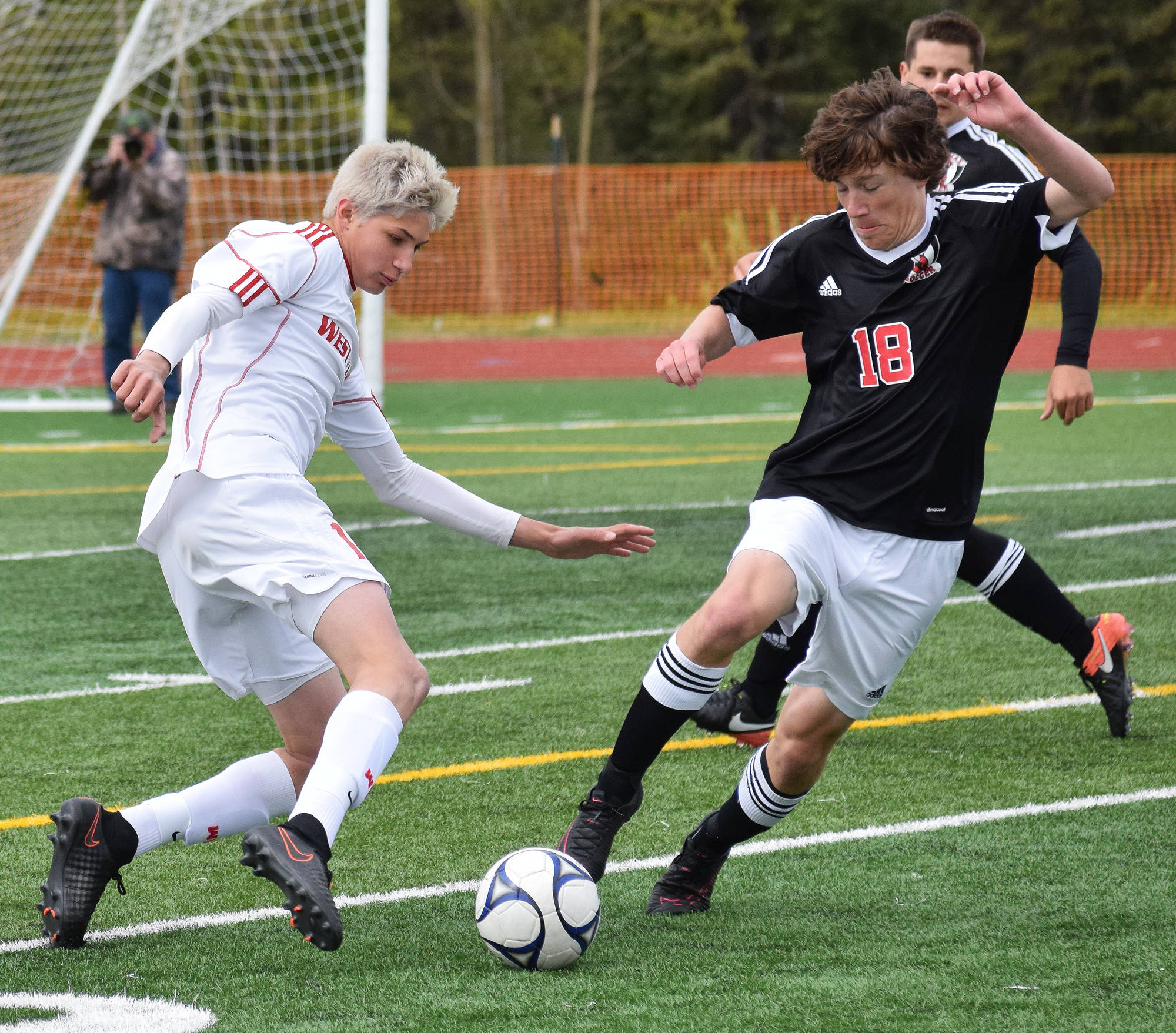 West Valley’s Vaughn Simpson (left) battles for possession against Kenai Central’s Damien Redder in Friday’s state tournament semifinal matchup at Service High School. (Photo by Joey Klecka/Peninsula Clarion)